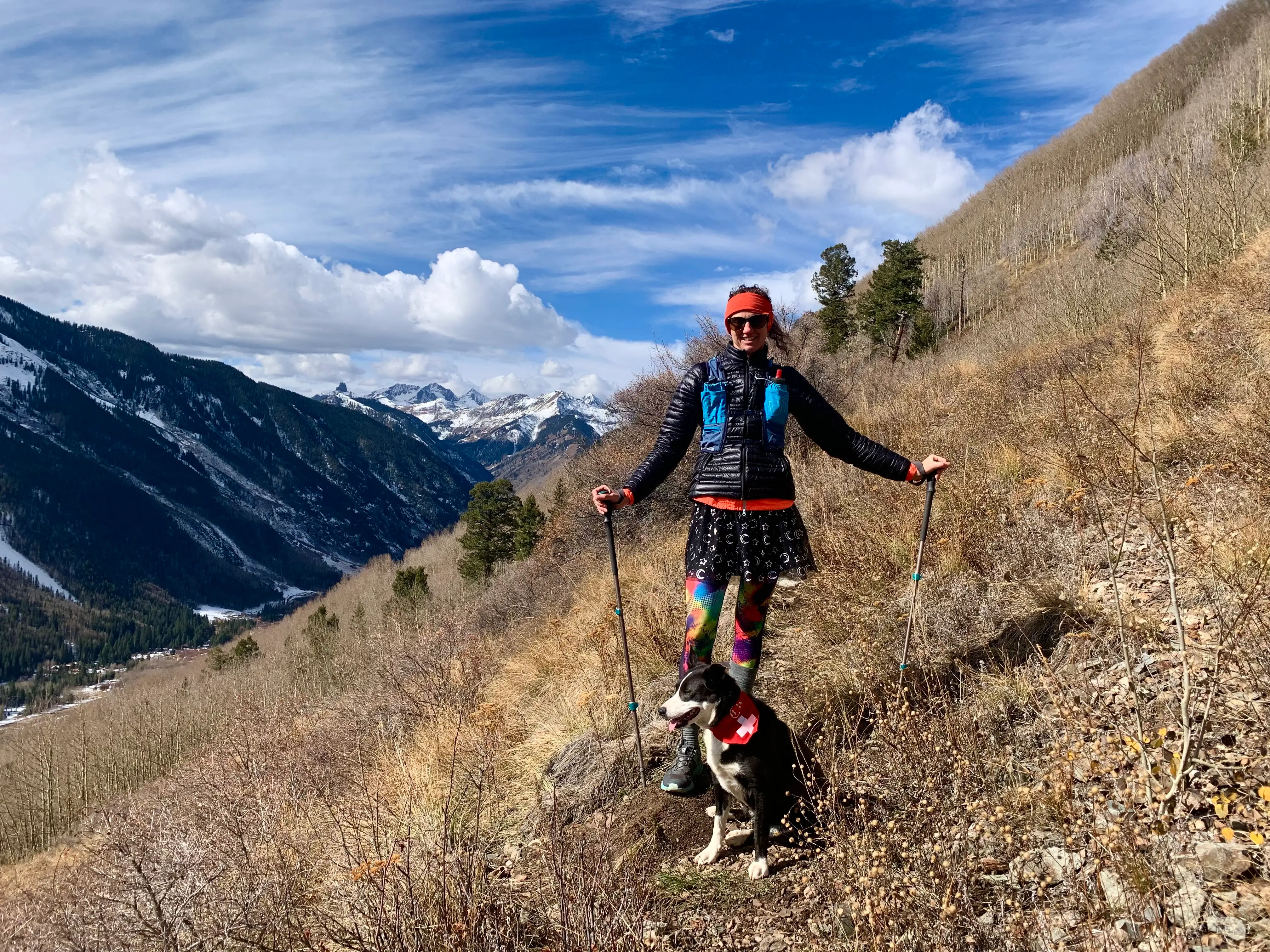 Woman in mountains with dog on leash