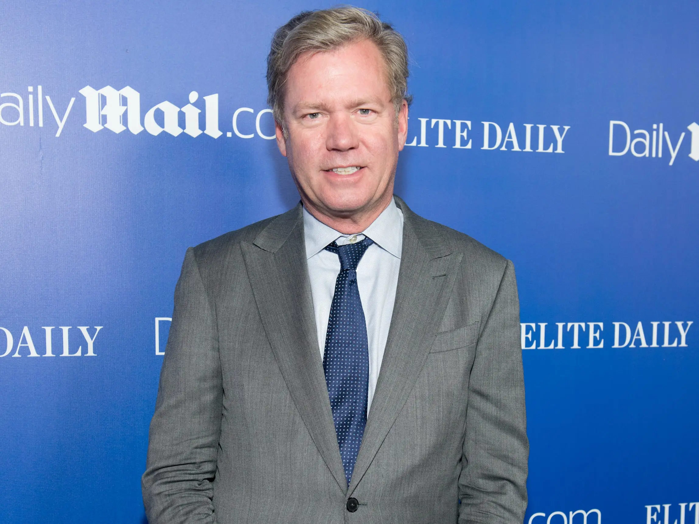 Chris Hansen in a grey suit