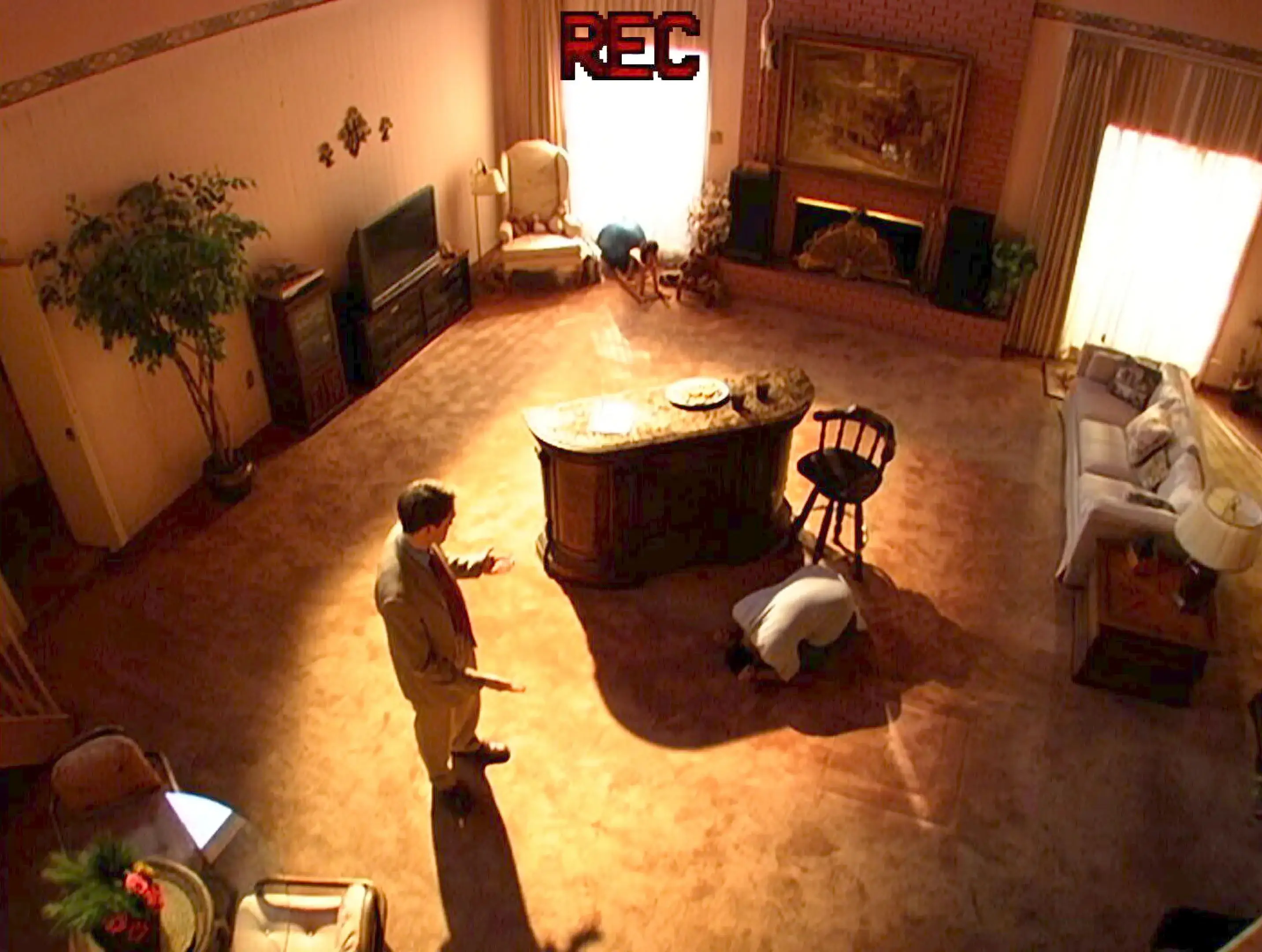 Robert Pattinson speaking to someone in a room who is on his hands and knees in Primetime movie