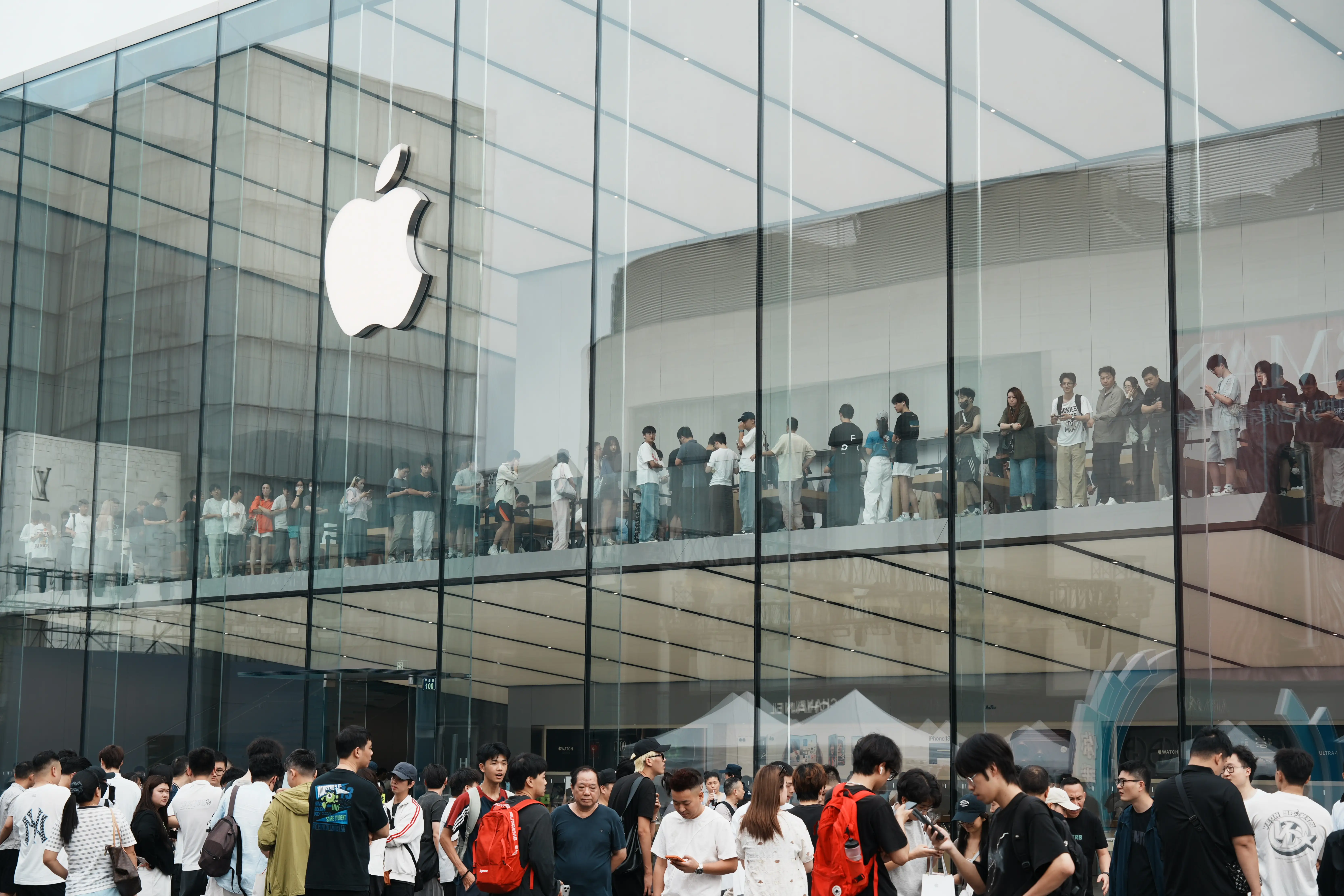 Shoppers in Hangzhou, China, line up outside an Apple store.