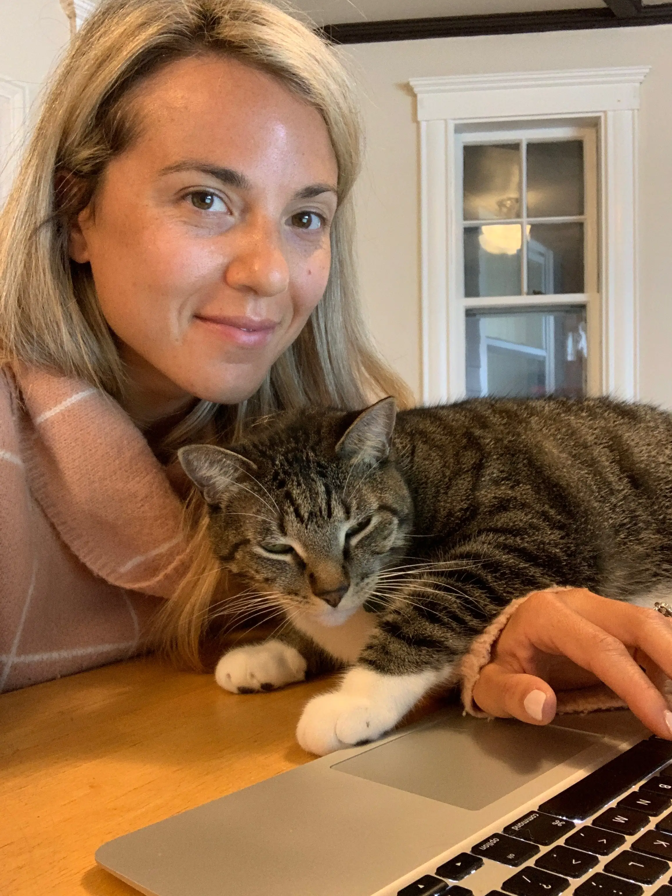 the author and her cat sitting in front of a laptop