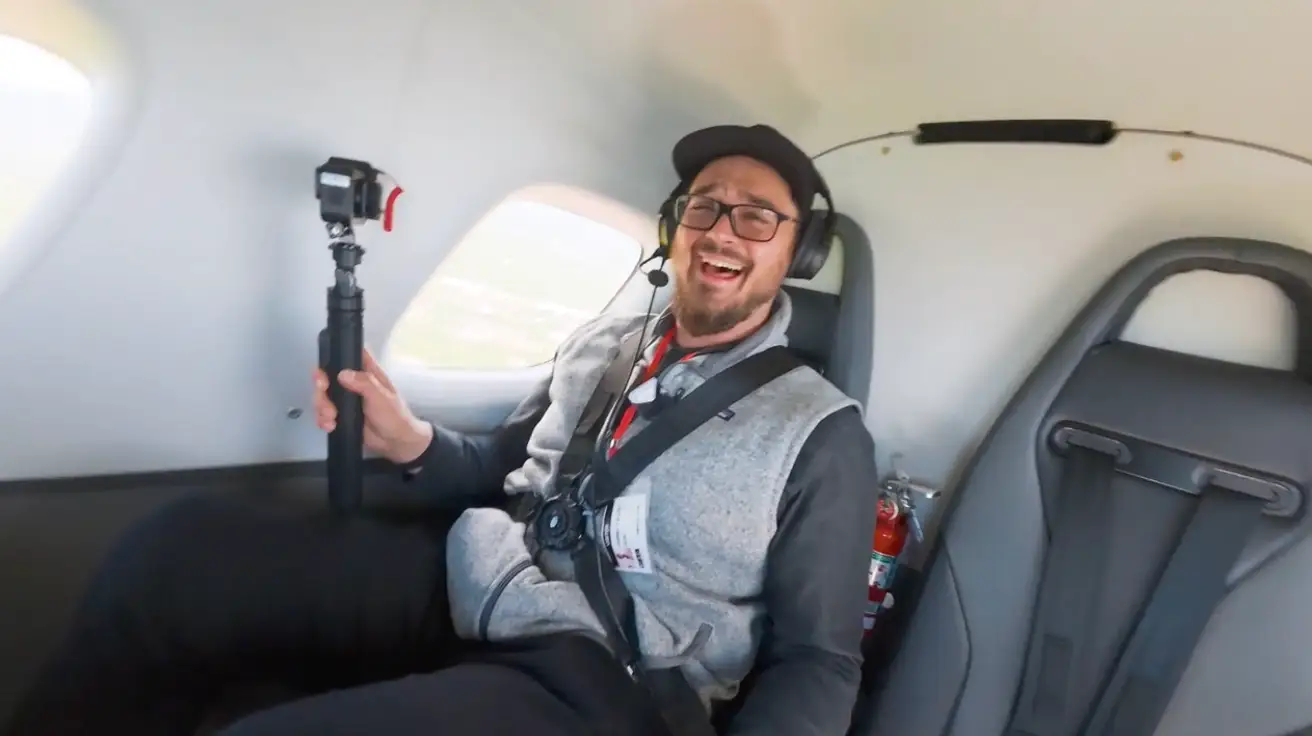 Business Insider producer Daniel Allen is riding on Beta's electric plane with a surprised expression at how fast it accelerates.