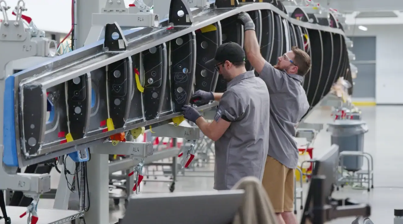 Beta employees working on the wing of one of its electric planes.