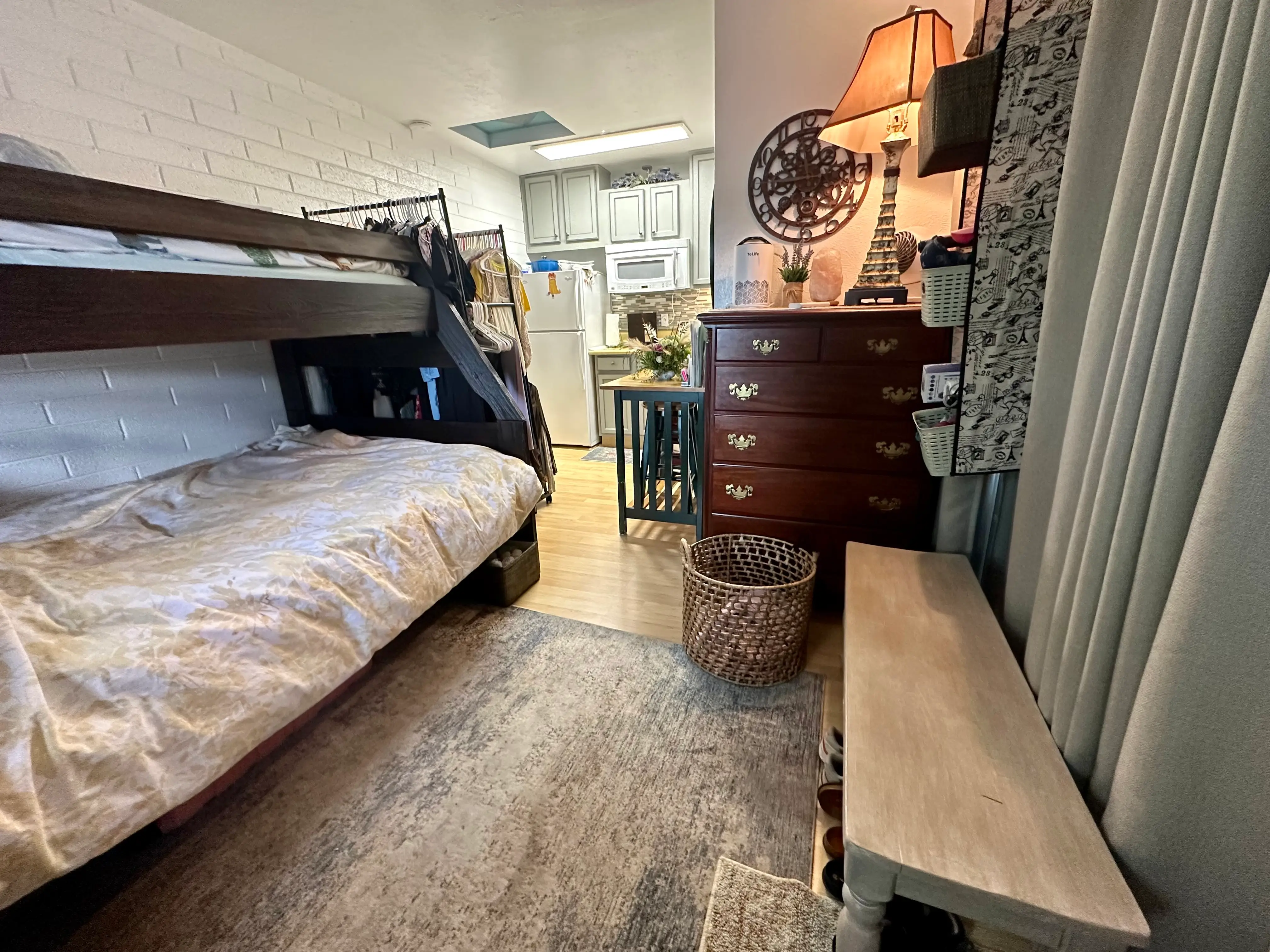 small converted garage with room for a bunk bed, dresser, and kitchenette