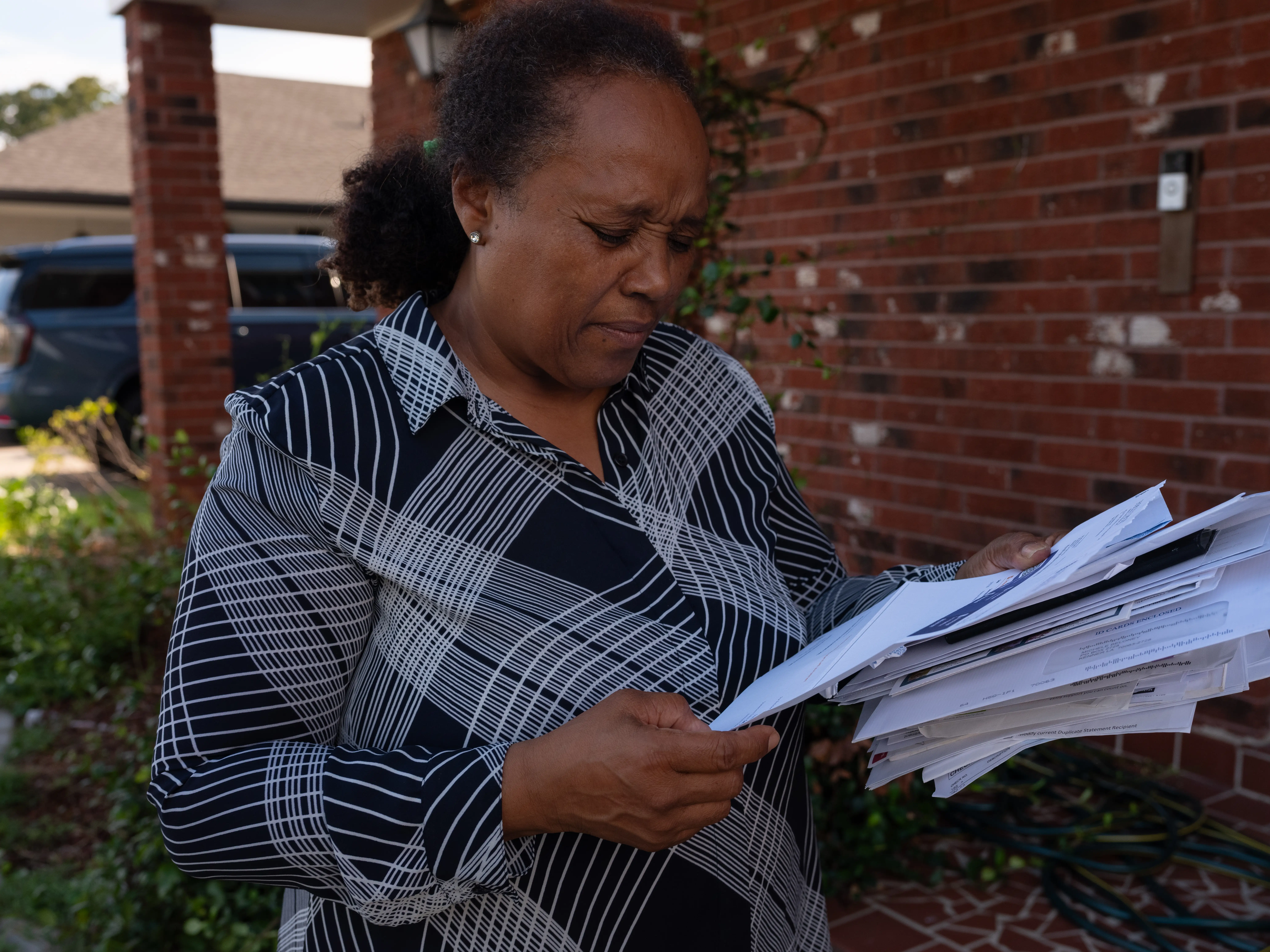 Michele Angela Brooks holding a pile of bills.