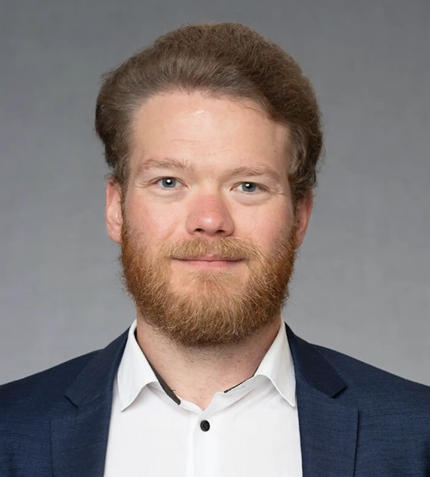 KPMG's Justin Johnsen in a white shirt with a blue blazer