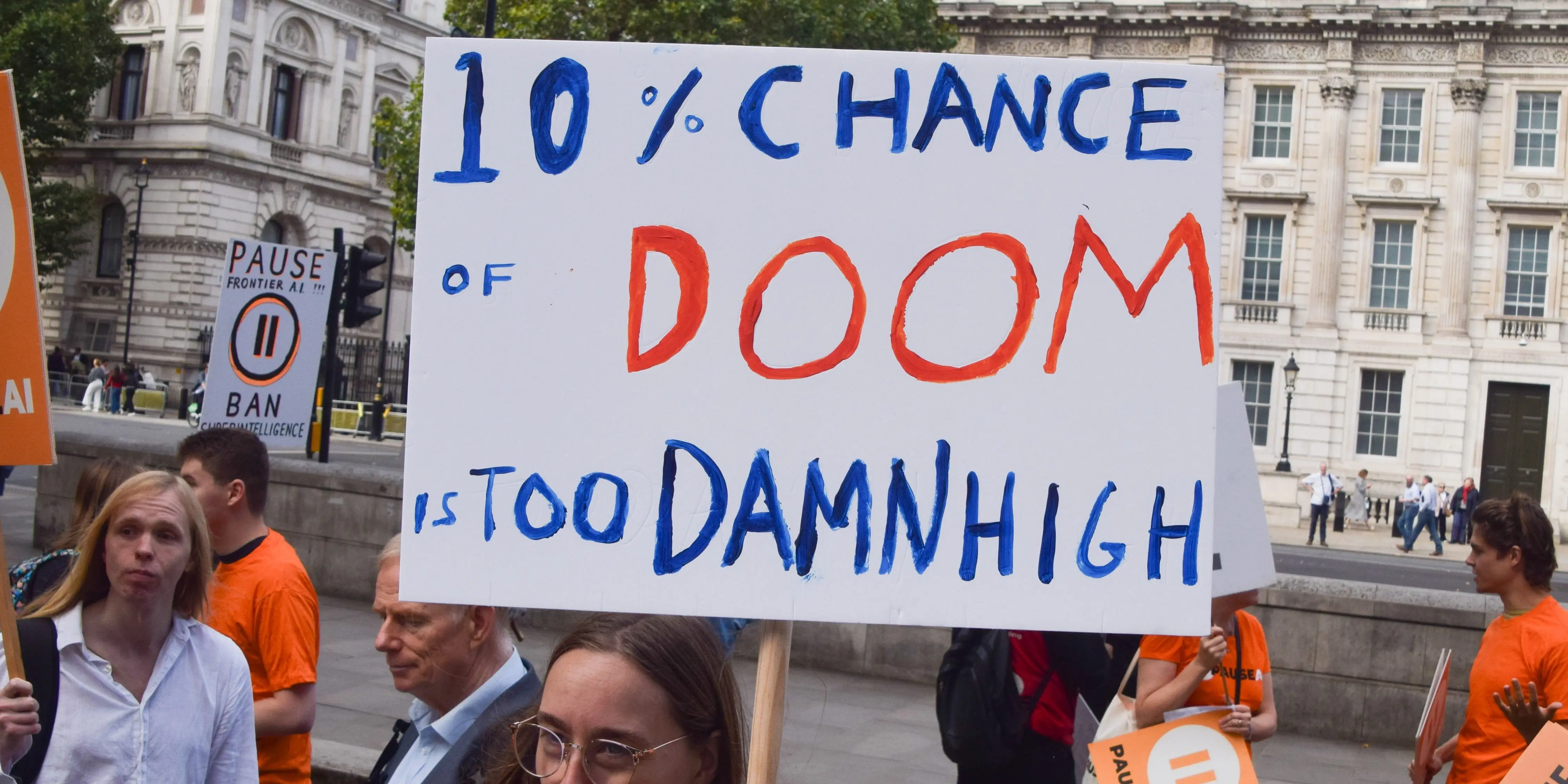 A protestor holds a sign that says,