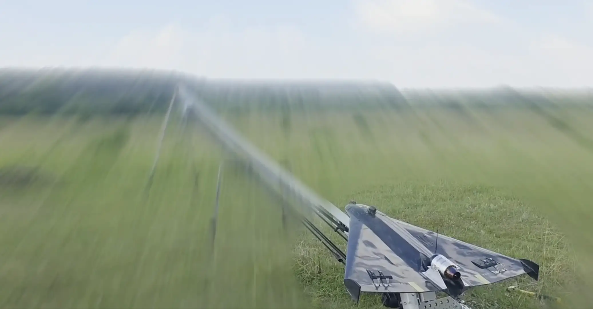 An unnamed delta-wing interceptor drone sits on a catapult launch rail.