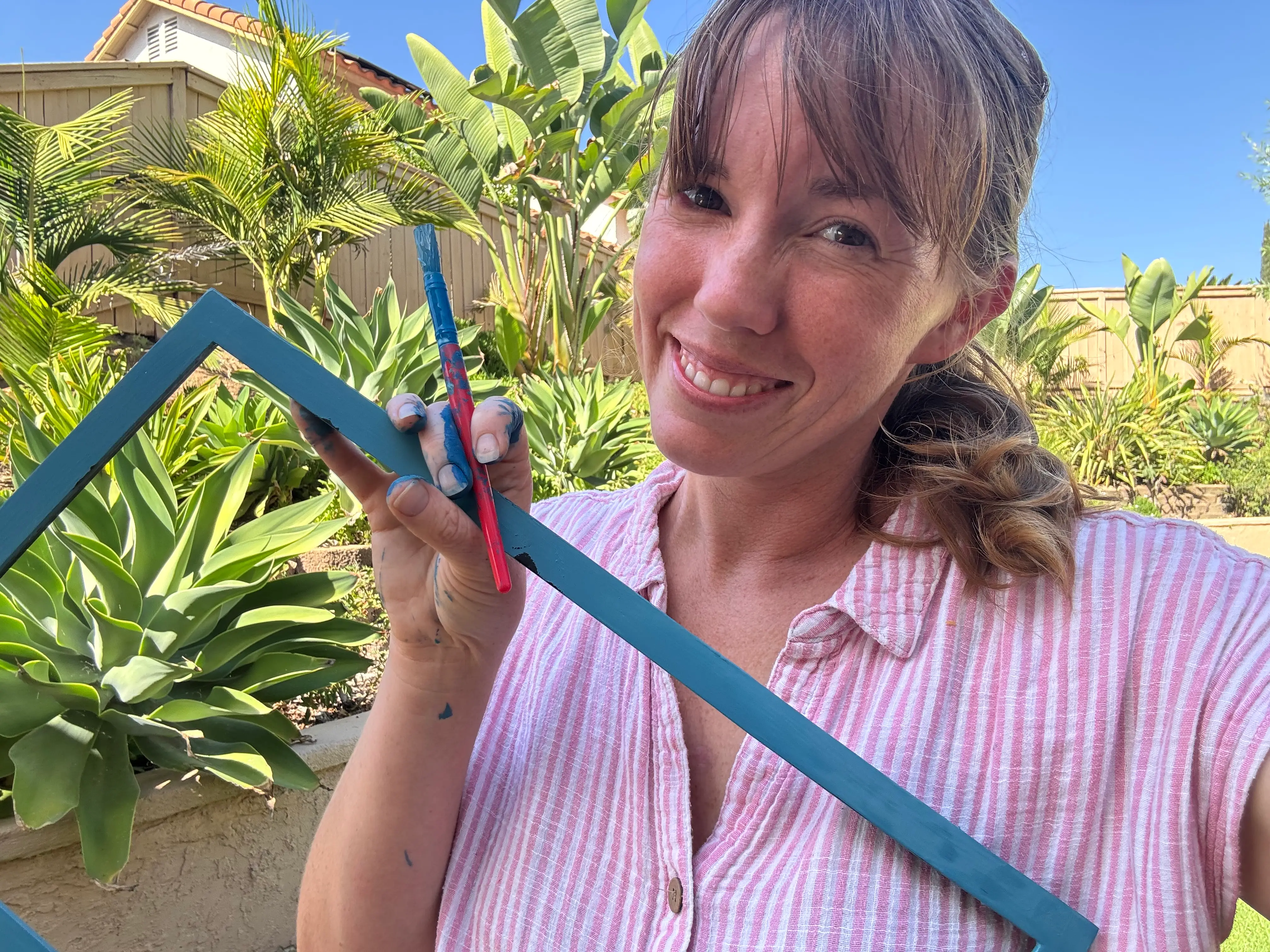 the author painting a picture frame