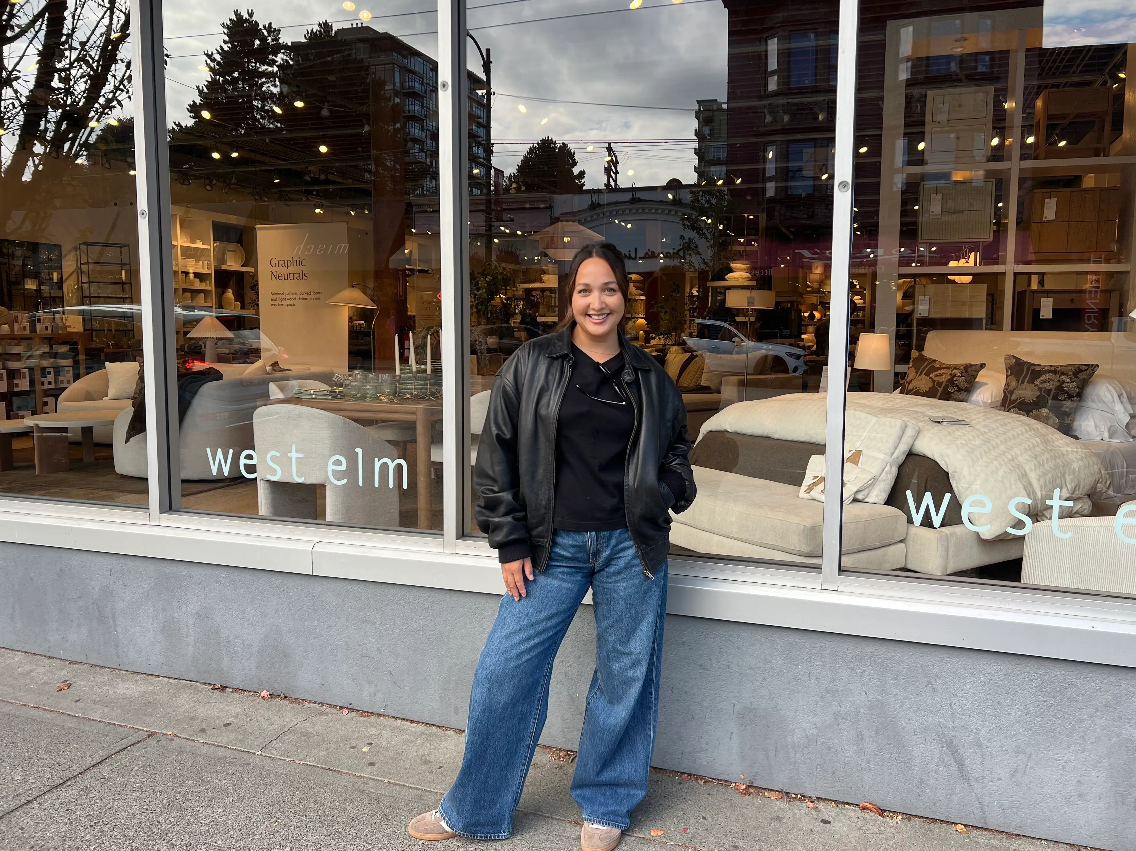 Carmen stands in front of a West Elm store.