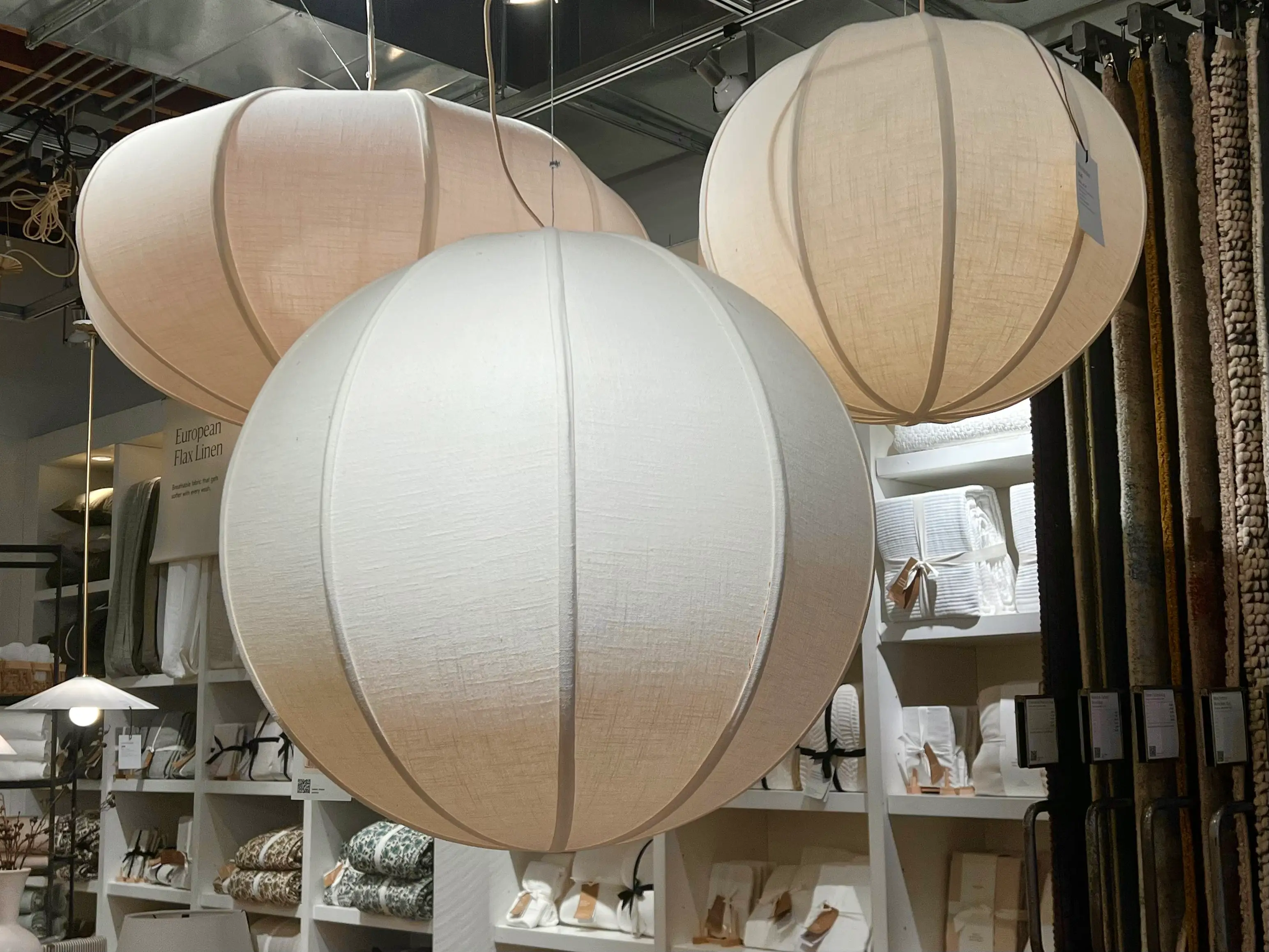 Three pendant lights in a linen texture hang from the ceiling.
