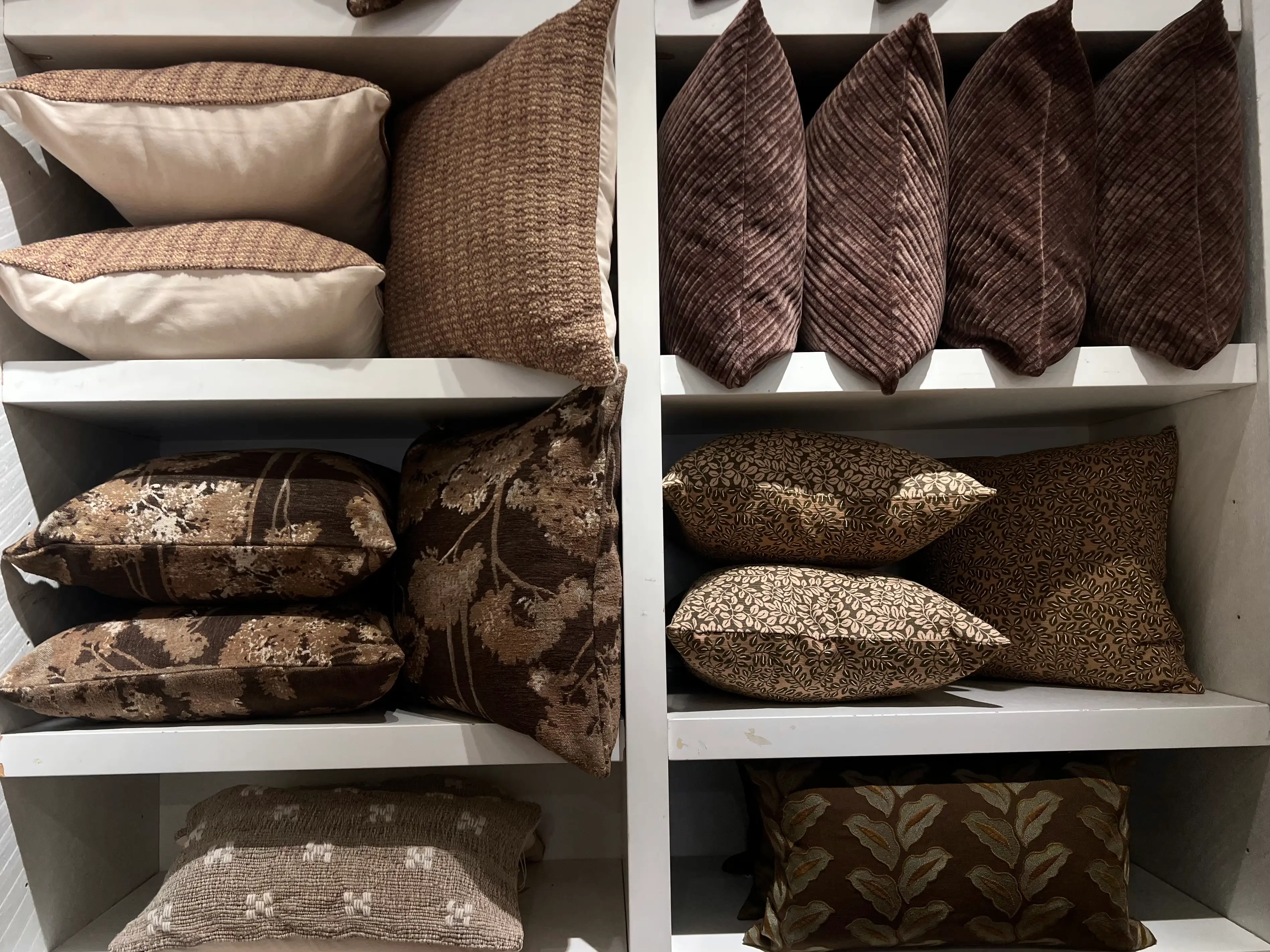 A selection of brown pillows in different shades and textures.