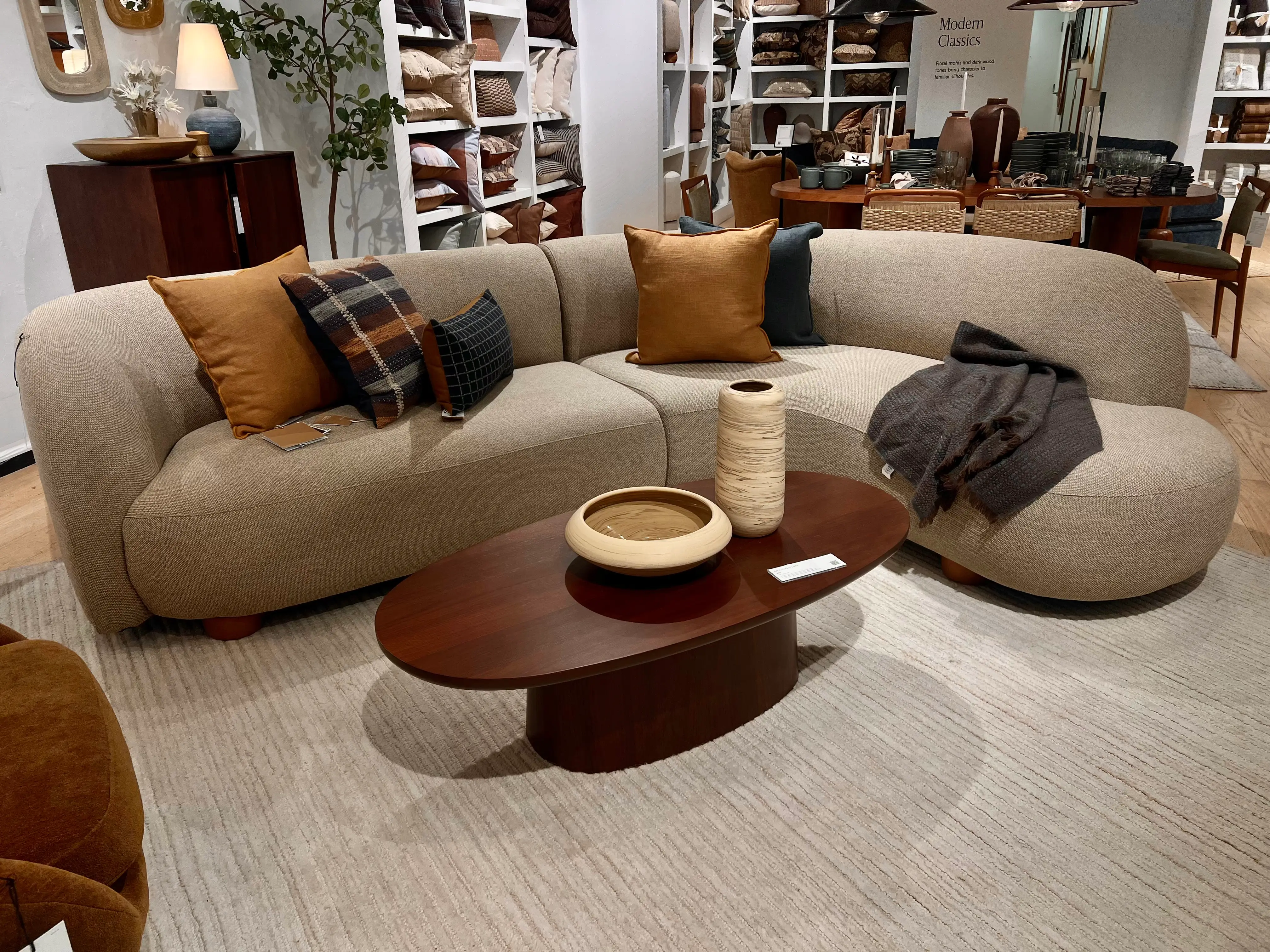 A couch and coffee table on a large area rug.