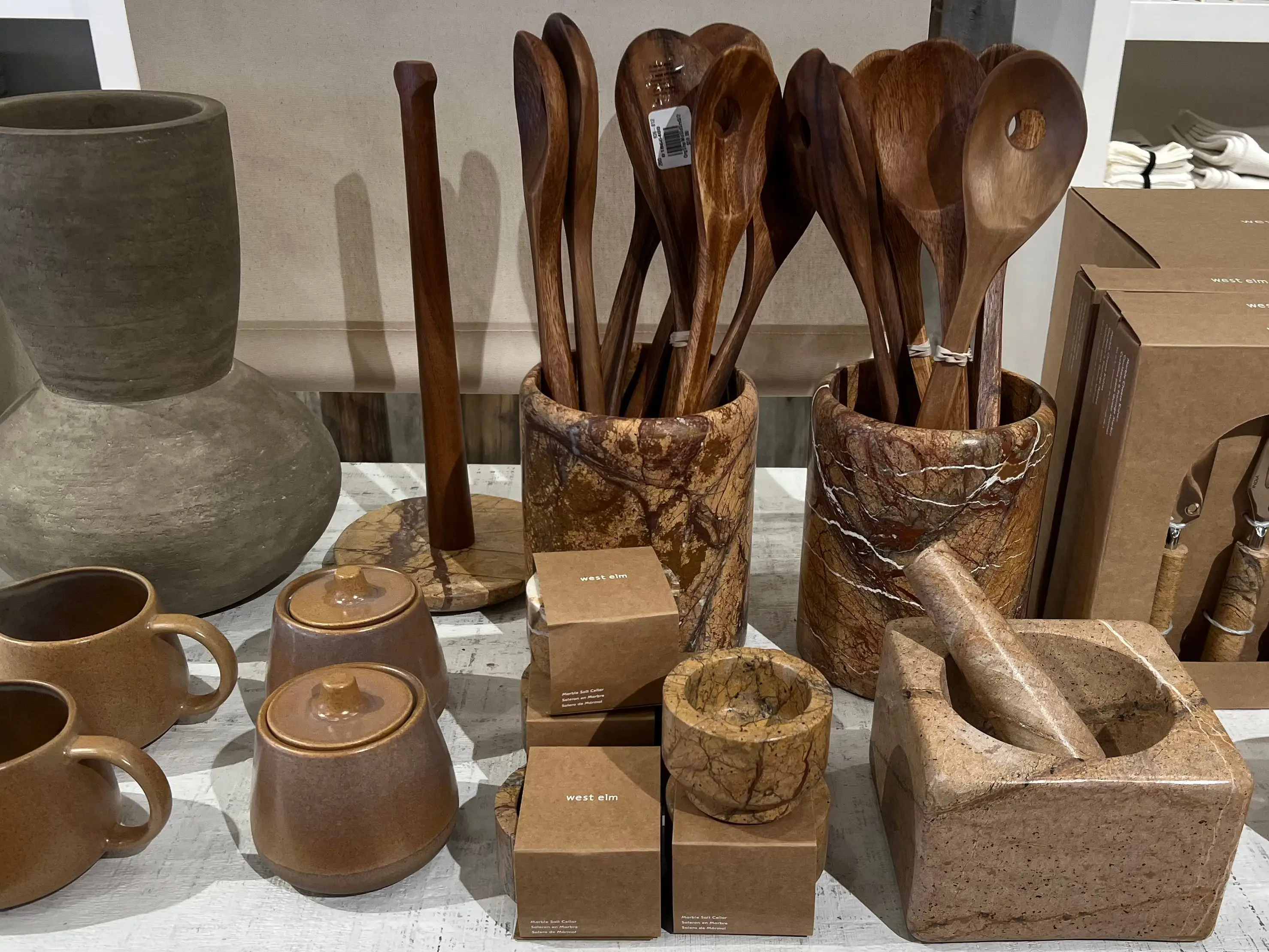 A selection of wooden utensils and marble kitchen tools.