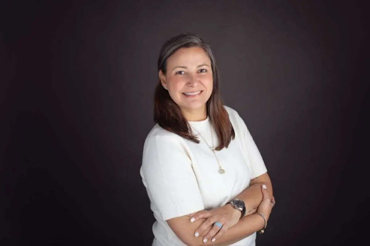 headshot of a woman in a white shirt