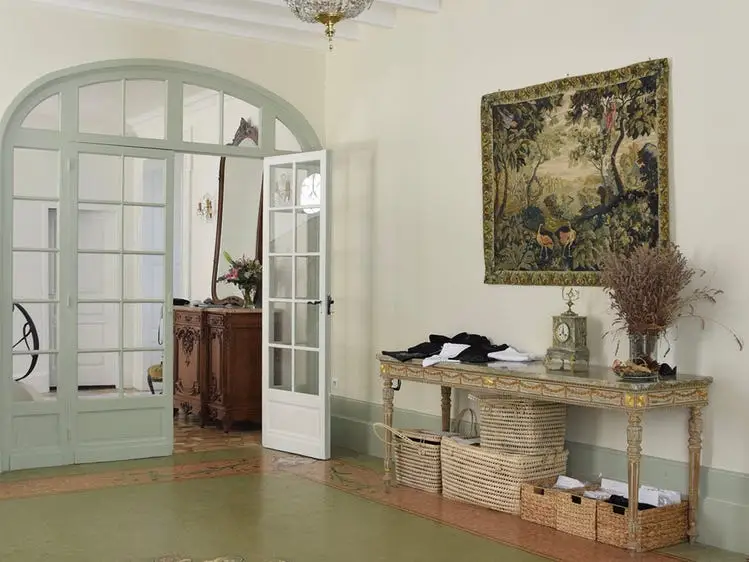 Entryway with mint-colored arch, artwork