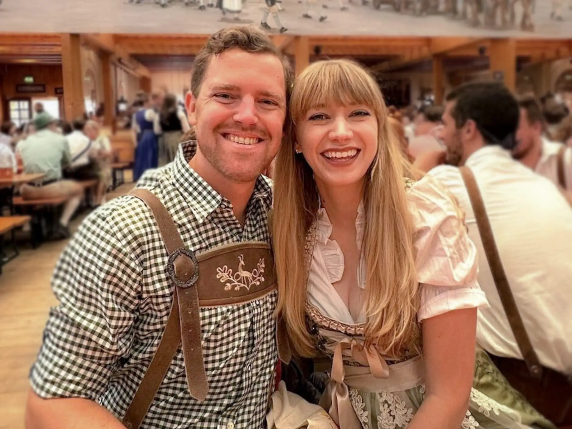 Emily and her husband wearing traditional Oktoberfest outfits.