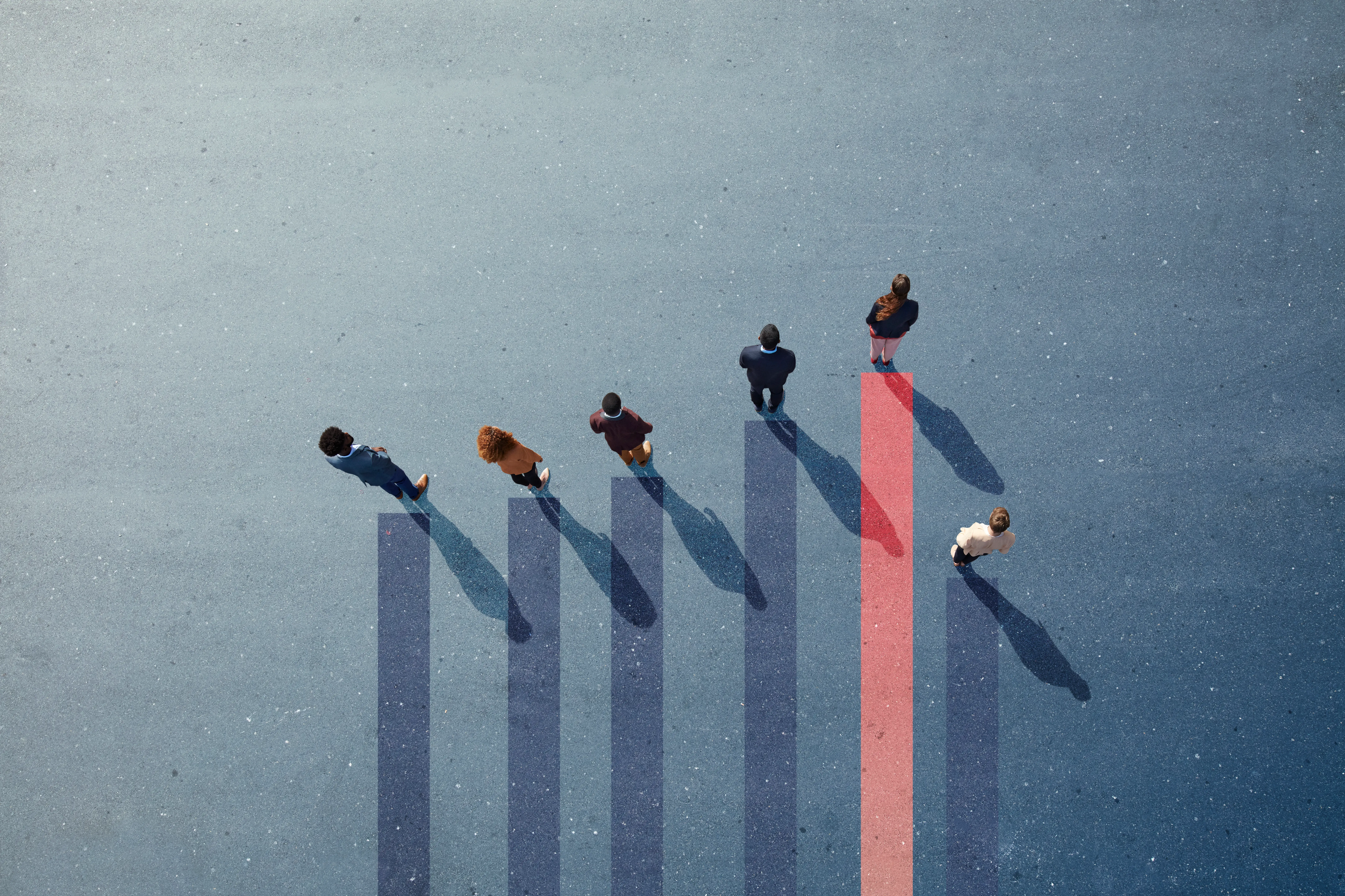 Group of young adults, photographed from above, on various painted tarmac surface, at sunrise.
