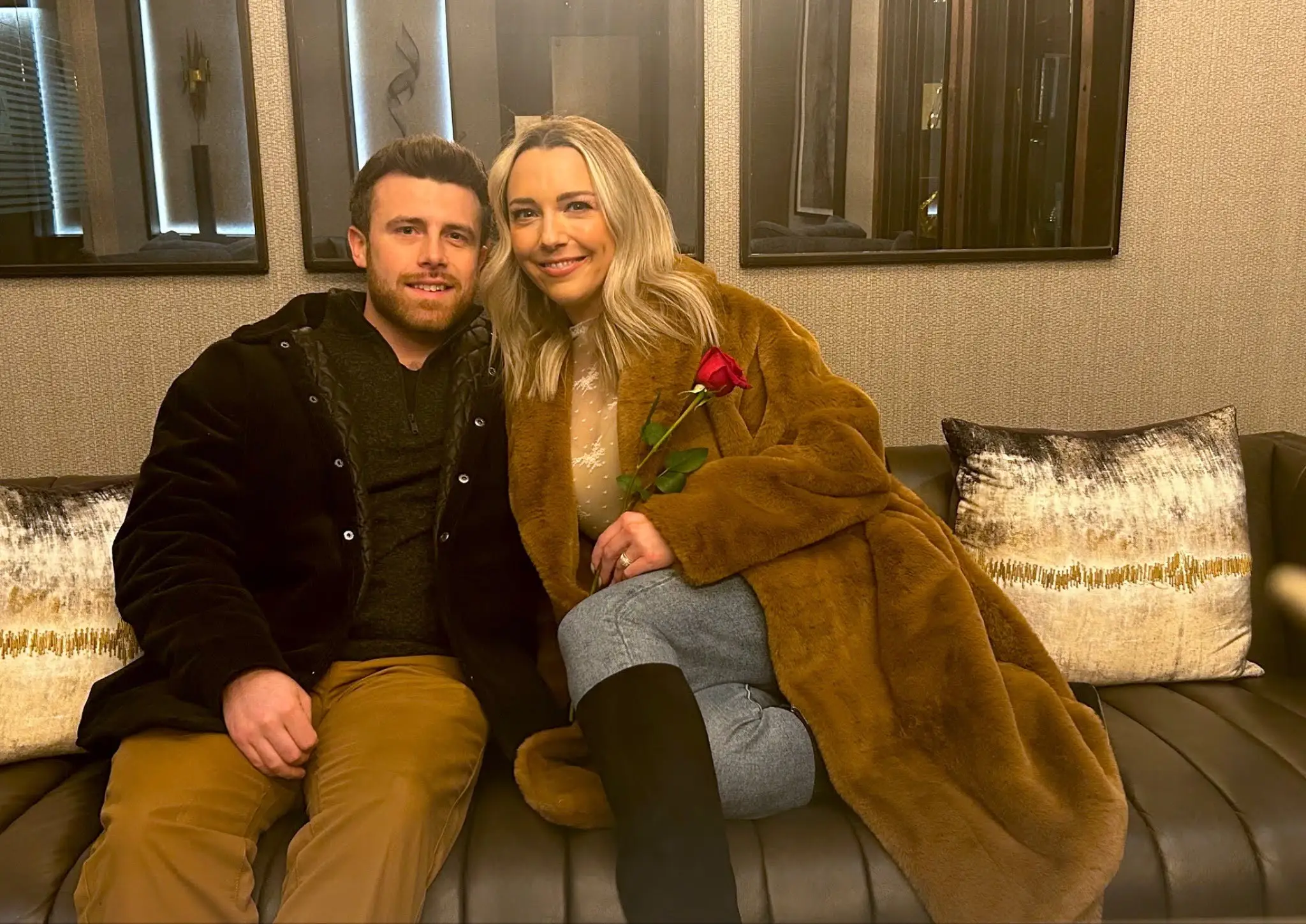 Rebecca and her husband sitting on a couch.