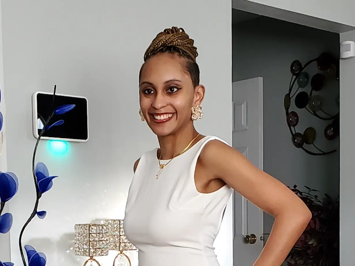 the author smiling and wearing a white dress