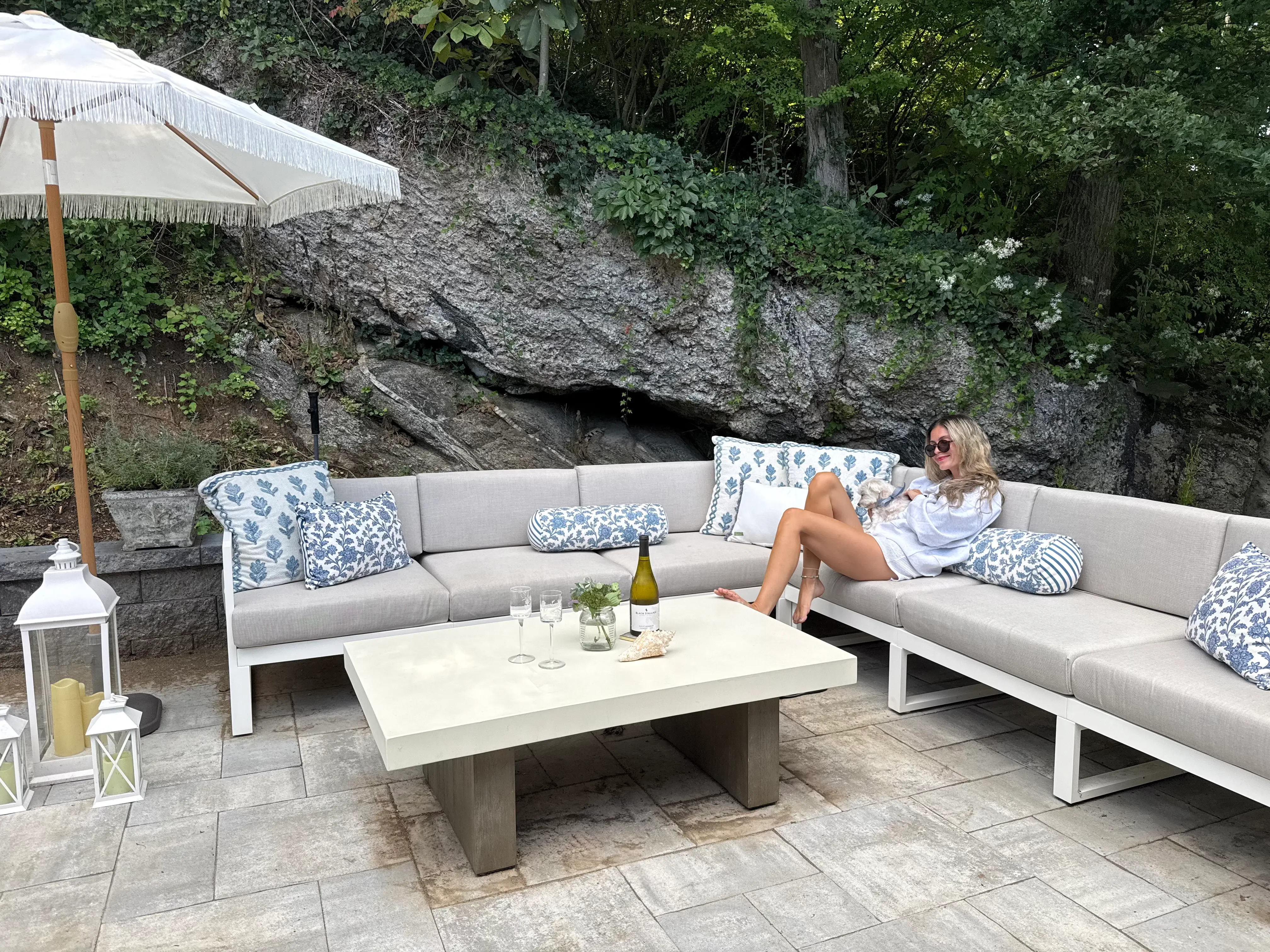 Woman sitting on sectional couch on patio