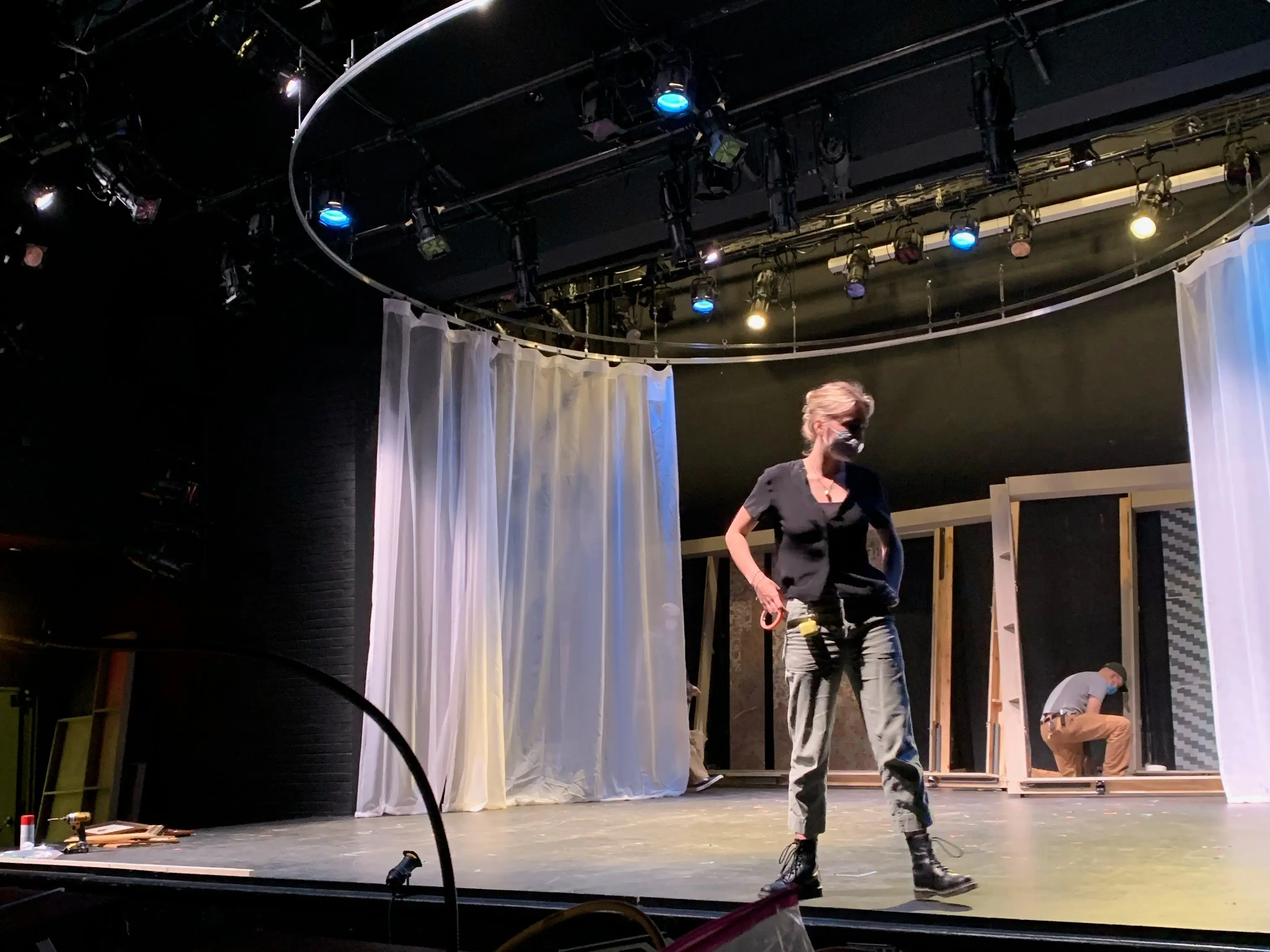 The writer is standing on the stage in a theater at Barnard College.