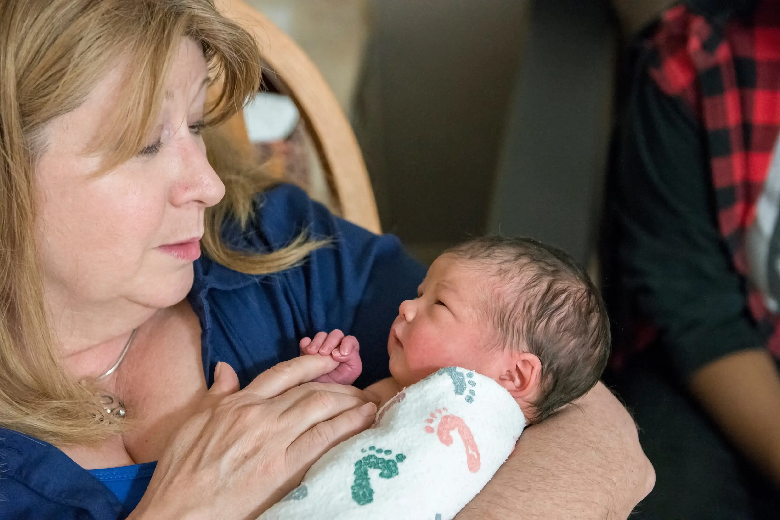 The author cradling her grandchild.