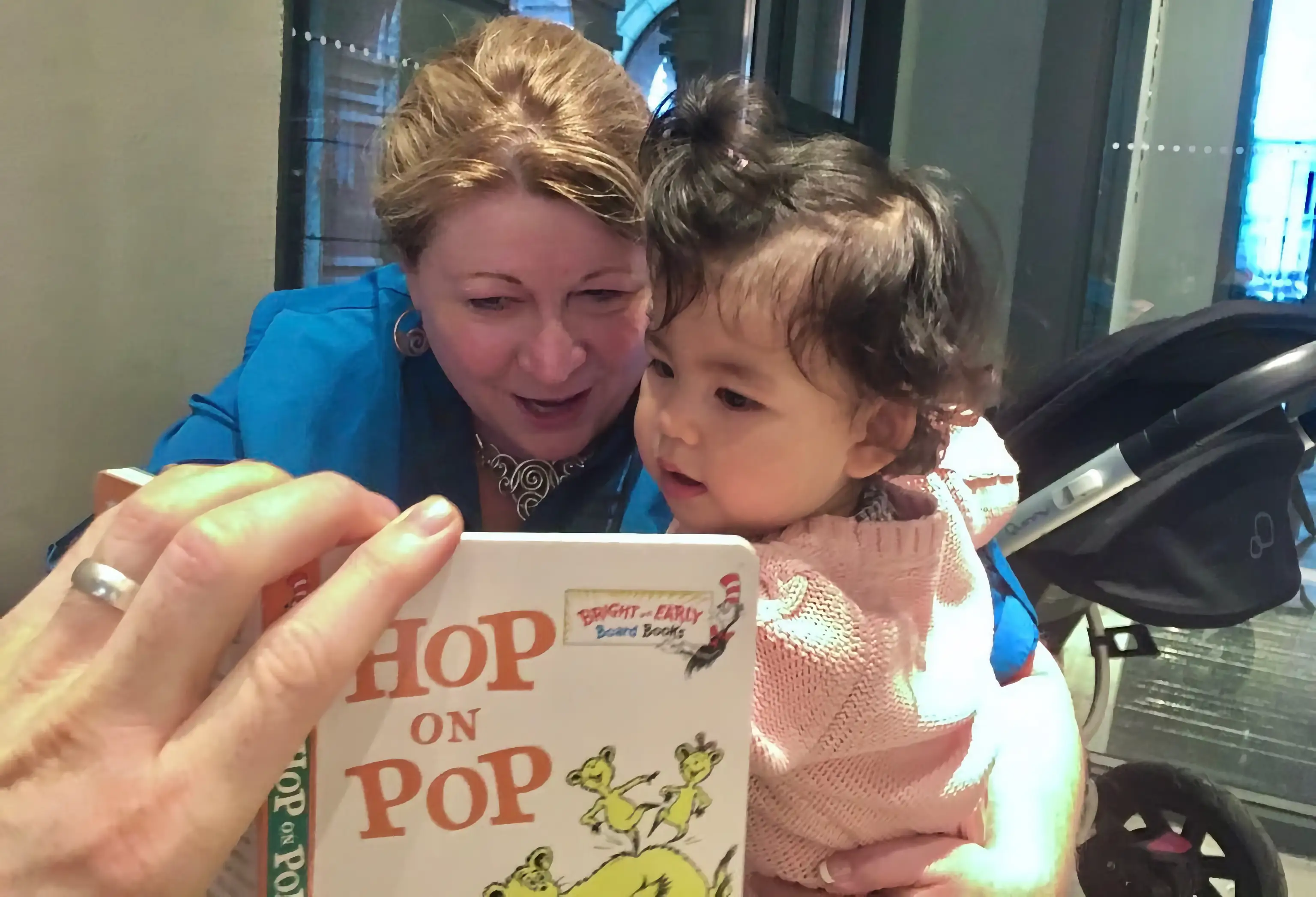 The author reads a book with her granddaughter.