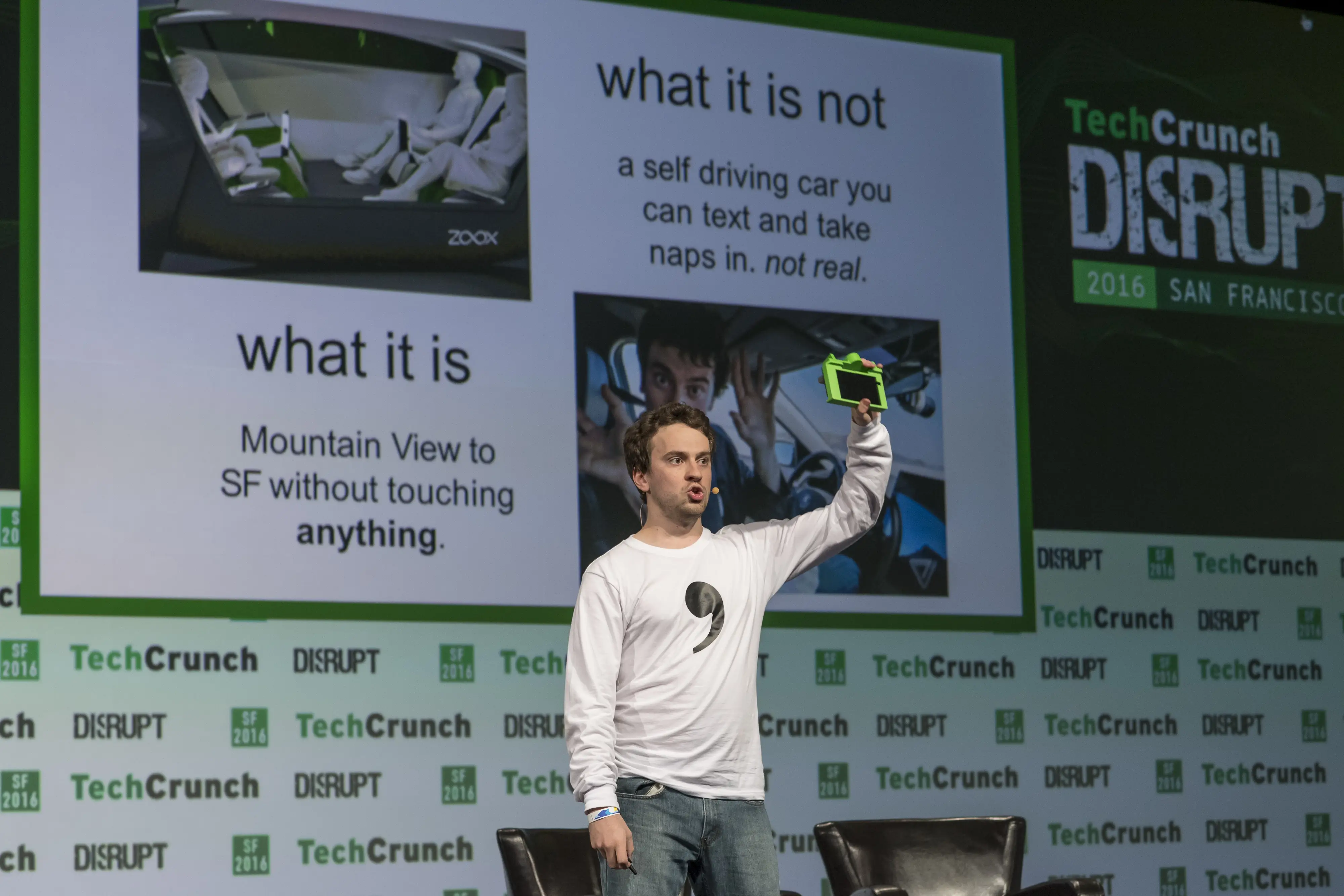 George Hotz, co-founder and chief executive officer at Comma.ai, holds the Comma One Self Driving device as he speaks during the TechCrunch Disrupt San Francisco 2016 Summit in San Francisco, California, U.S., on Tuesday, Sept. 13, 2016. TechCrunch Disrupt, the world's leading authority in debuting revolutionary startups, gathers the