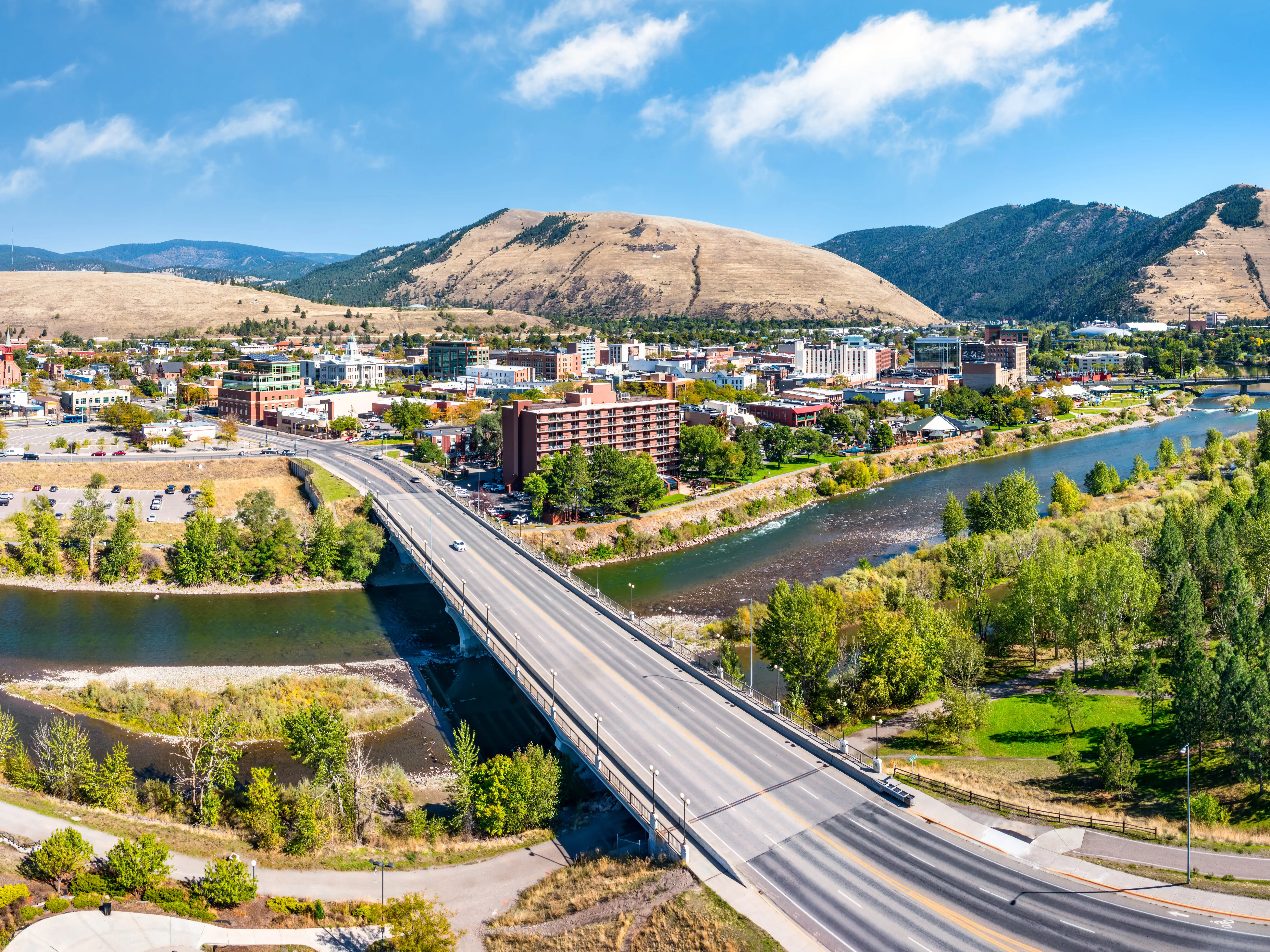 Aerial panorama of Missoula, Montana, above Beartracks Bridge. Missoula is a city in and the county seat of Missoula County, Montana. It is located along the Clark Fork River.