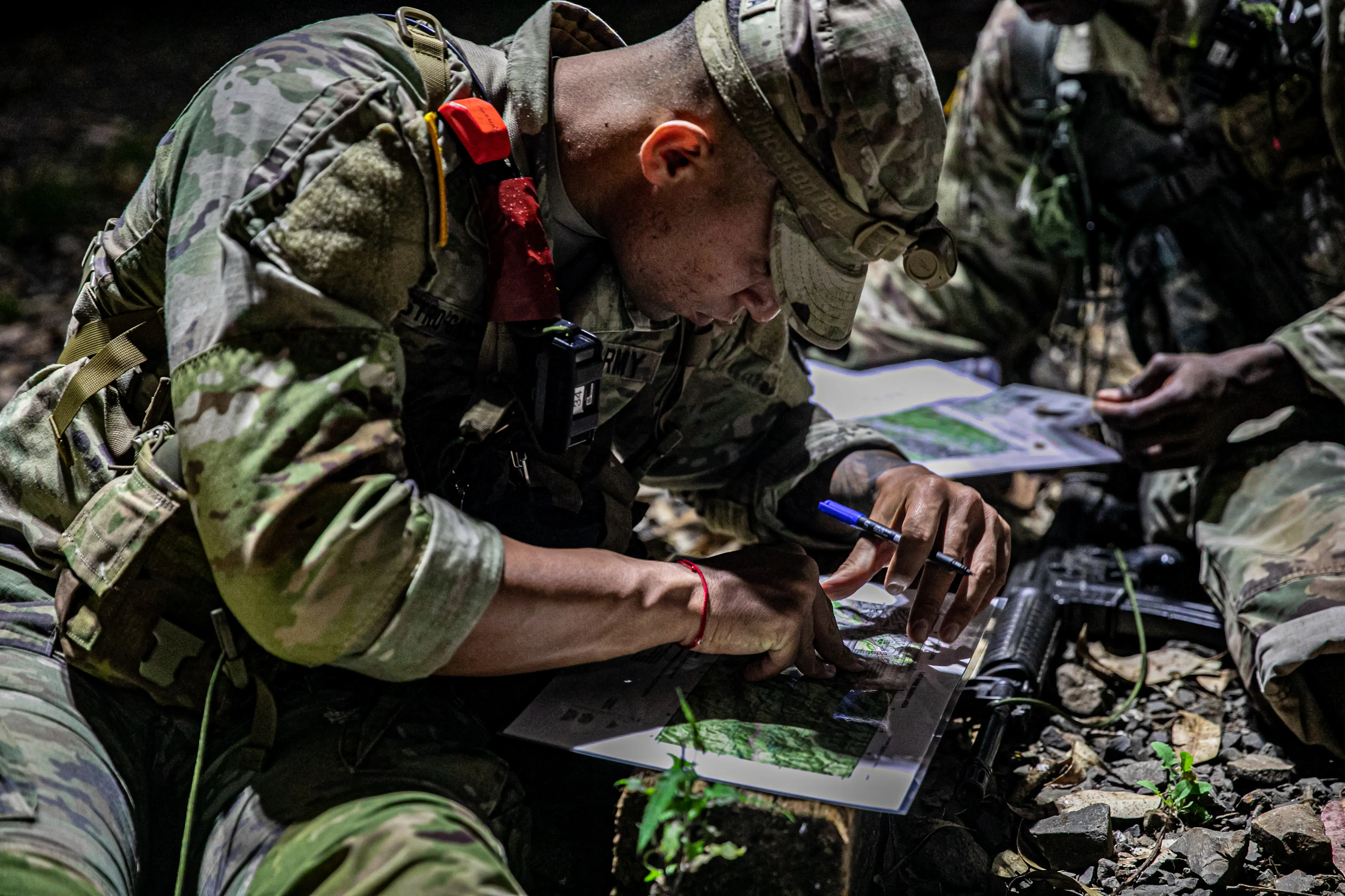 A soldier plots points for land navigation at Schofield Barracks East Range, Hawaii on June 2, 2021.