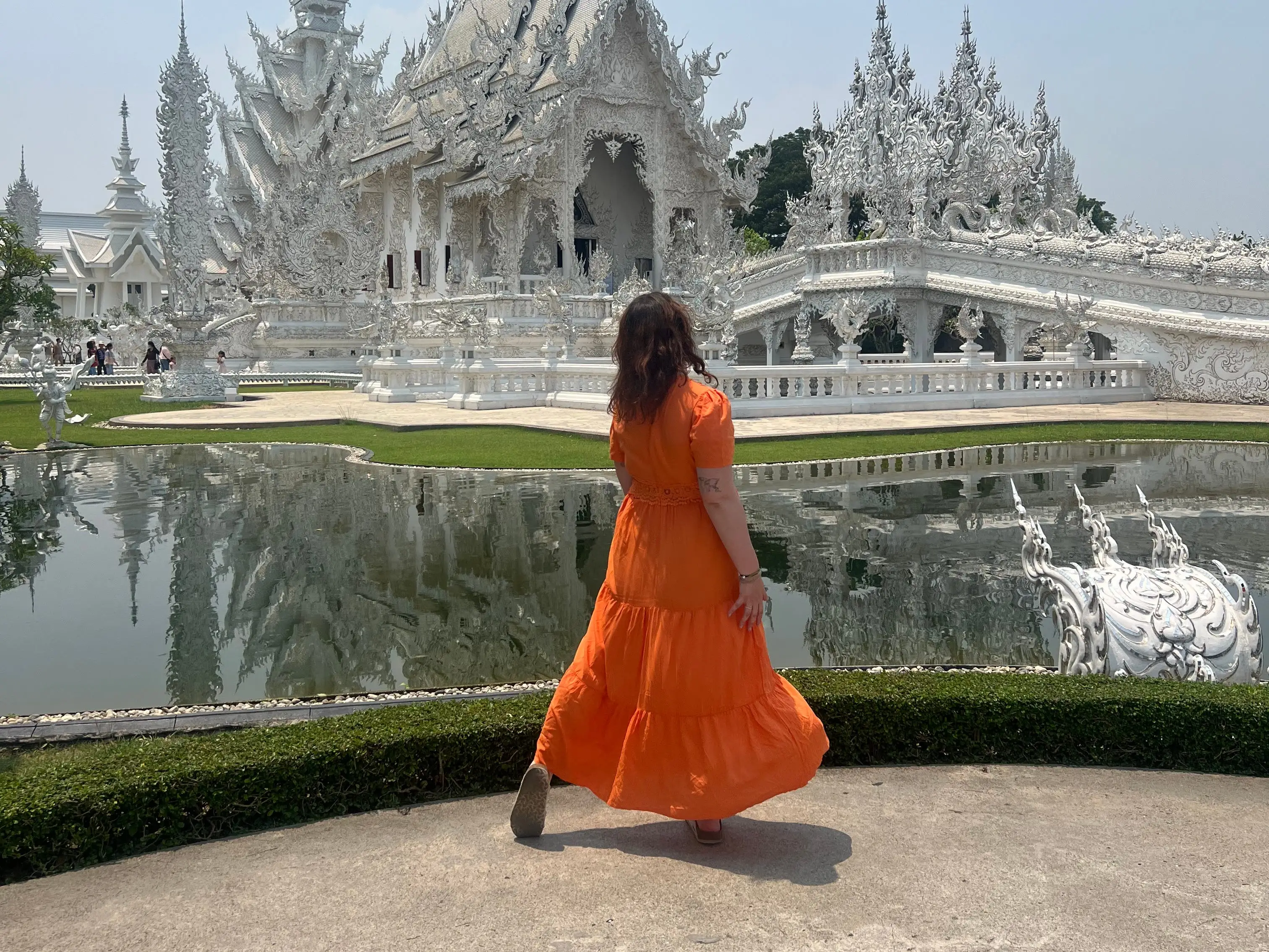 A woman in an orange dress in Southeast Asia.