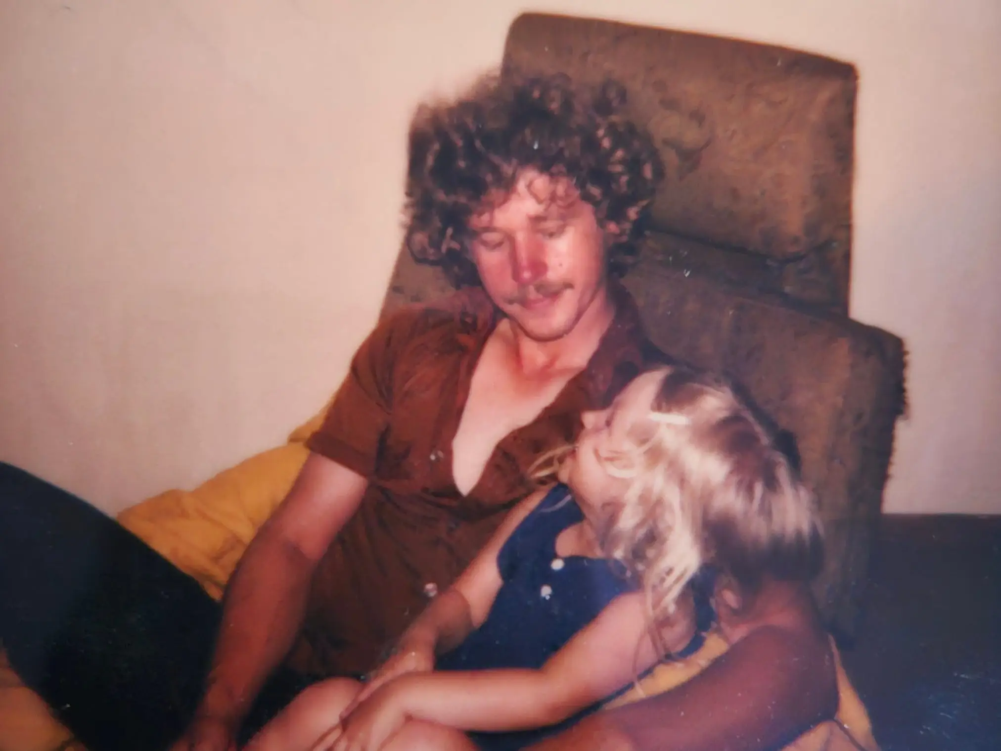 A photograph of Heather as a child with her dad