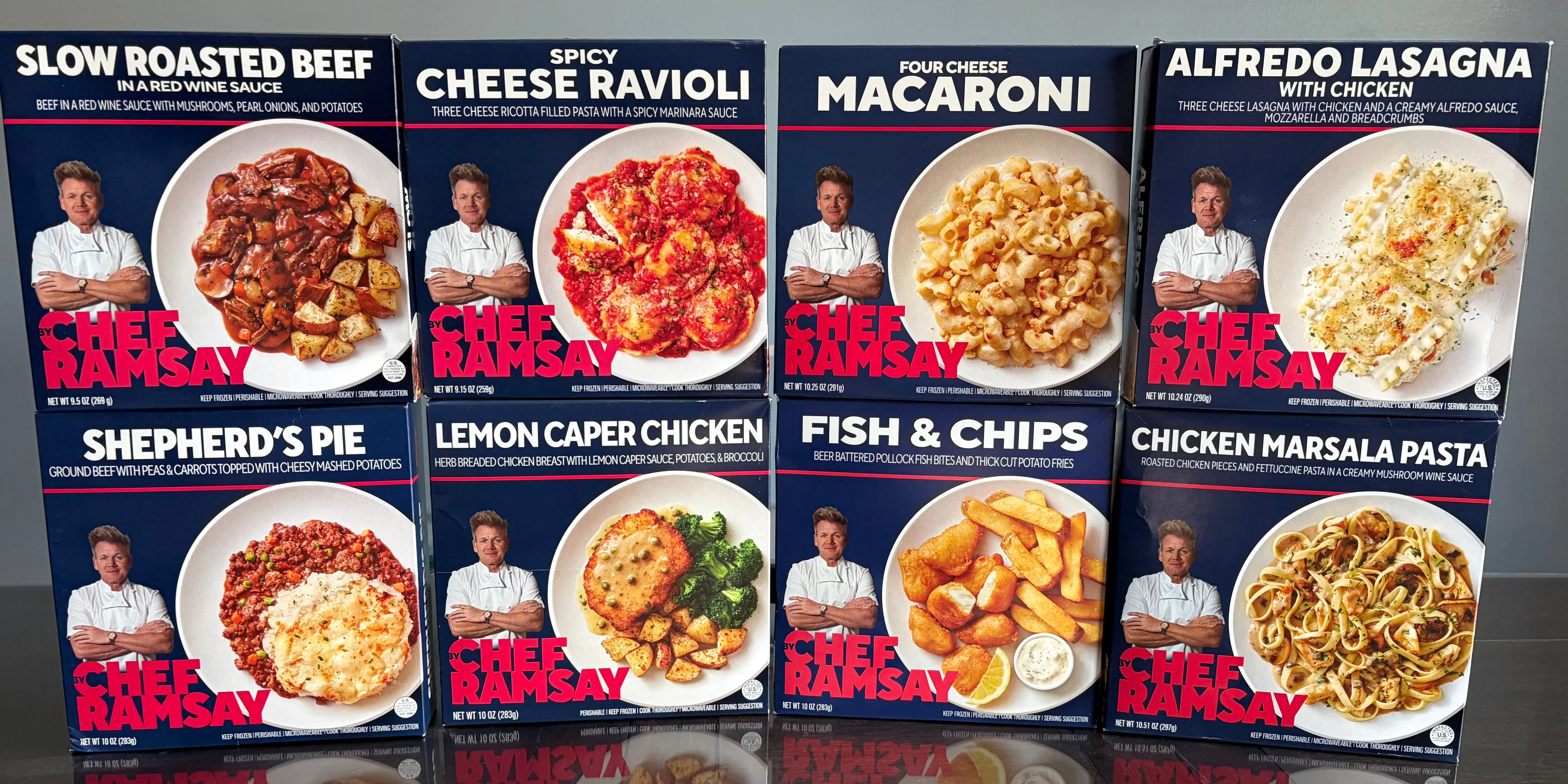 Eight boxes of frozen meals from the By Chef Ramsay line. They are stacked in two rows of four.