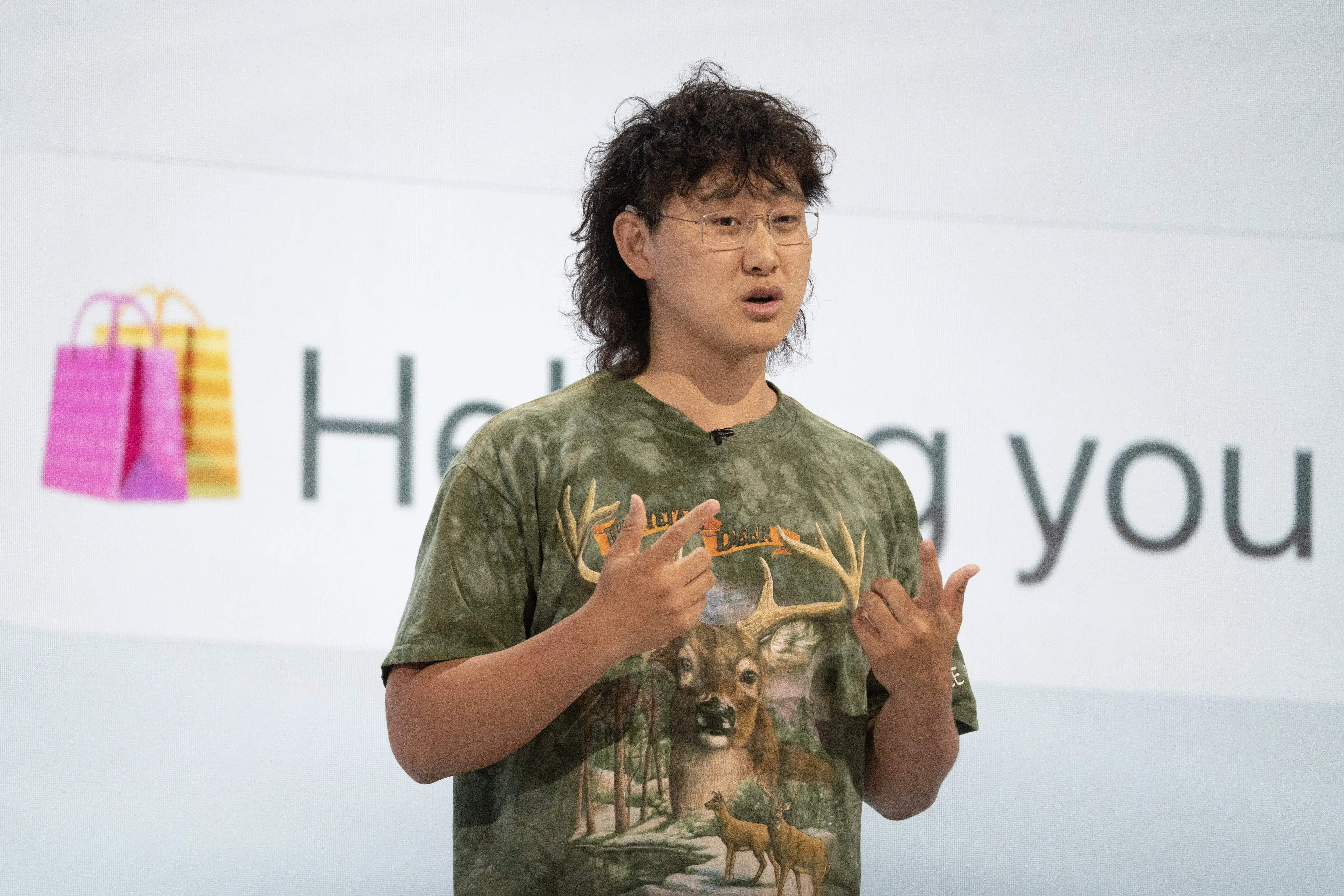 Alexandr Wang, Meta's chief AI officer, gives a keynote address in a camo shirt.