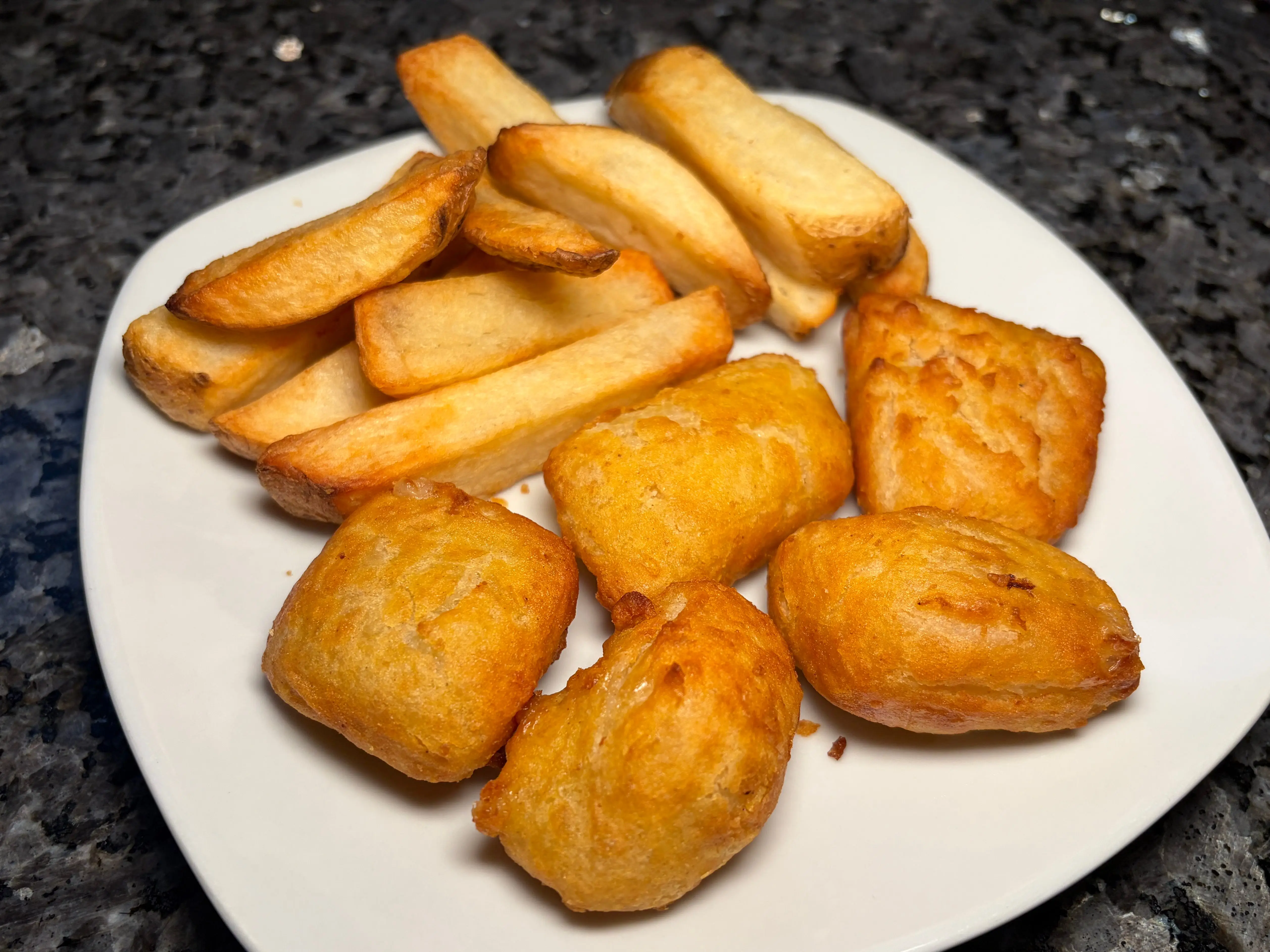 Fish and chips on a white plate.