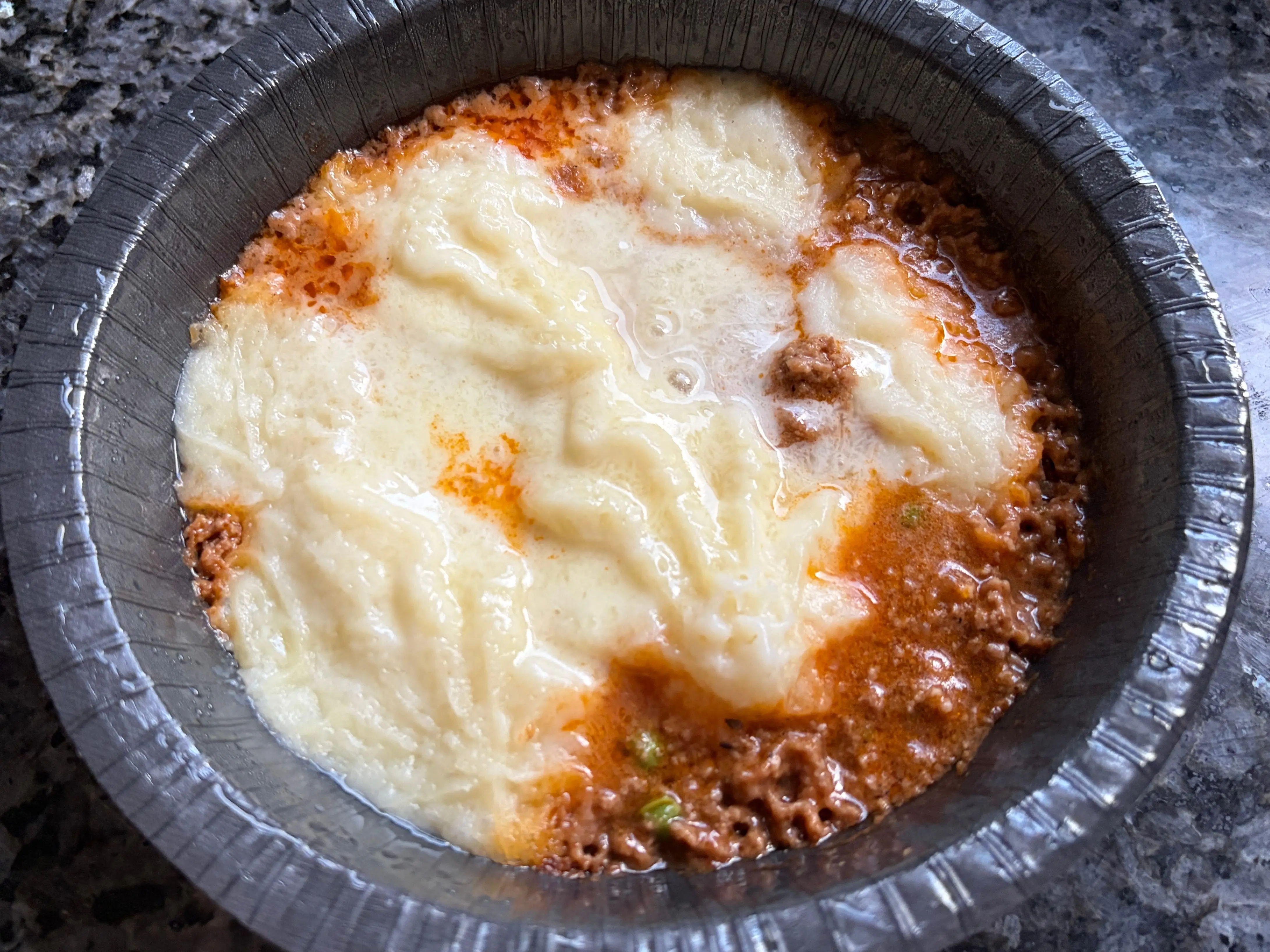 A shepherd's pie in a microwavable bowl.