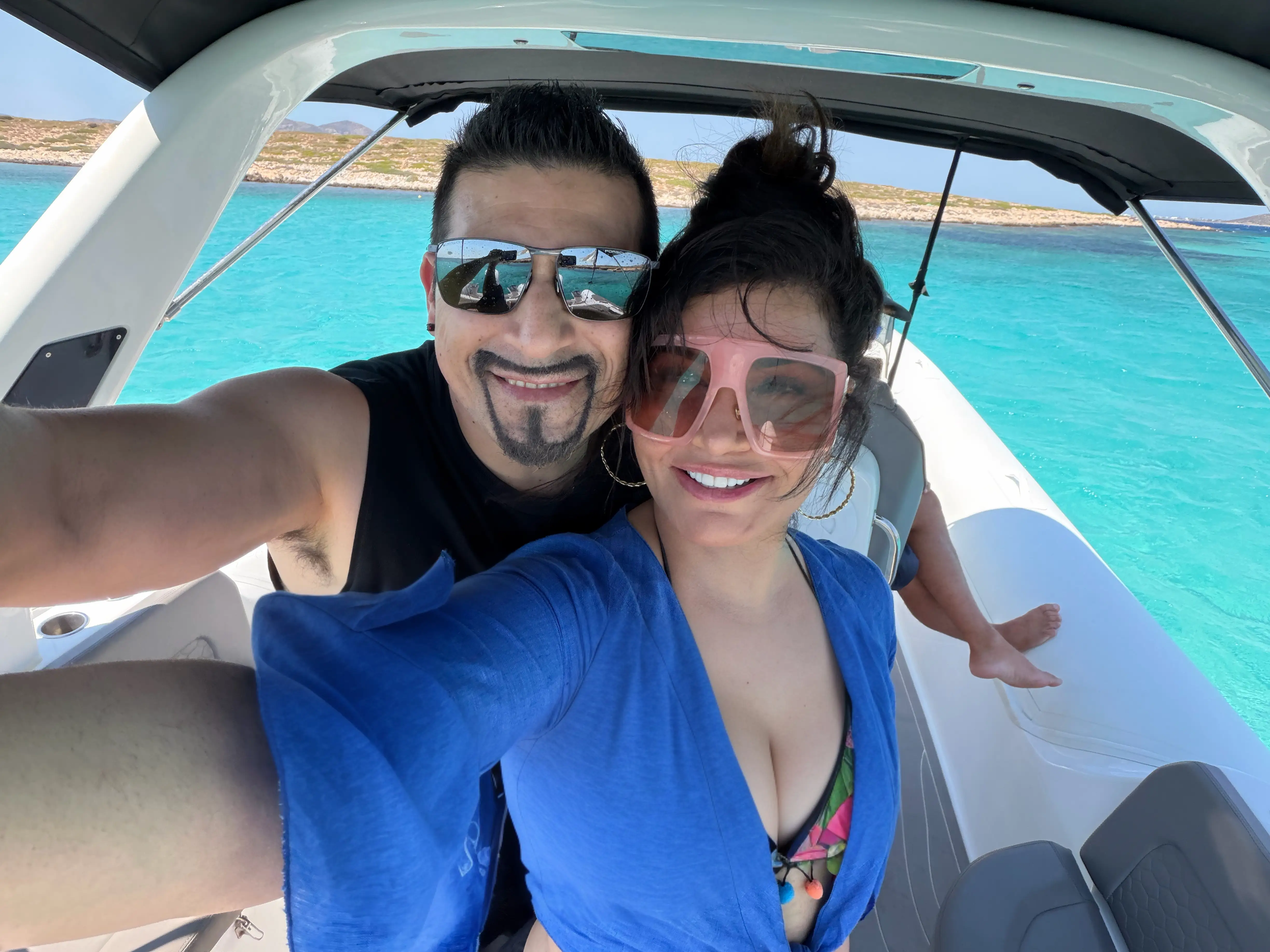 Sameera Sullivan and her husband Tim smiling from a boat on clear blue water