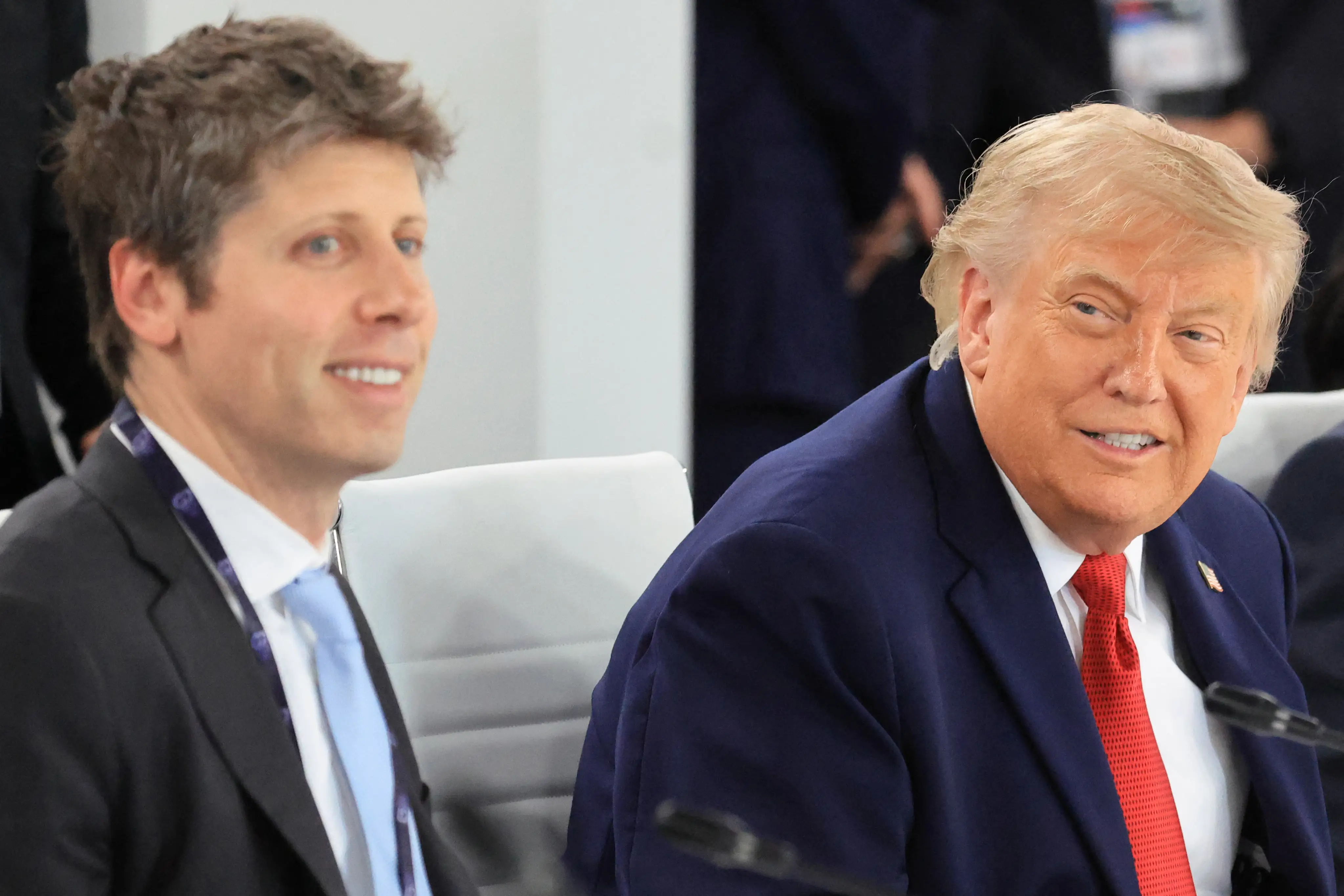 OpenAI CEO Sam Altman smiling on the left with a slouching President Donald Trump on the right side of the picture. They are at a lunch meeting at the G7 summit, in France, on June 17, 2026