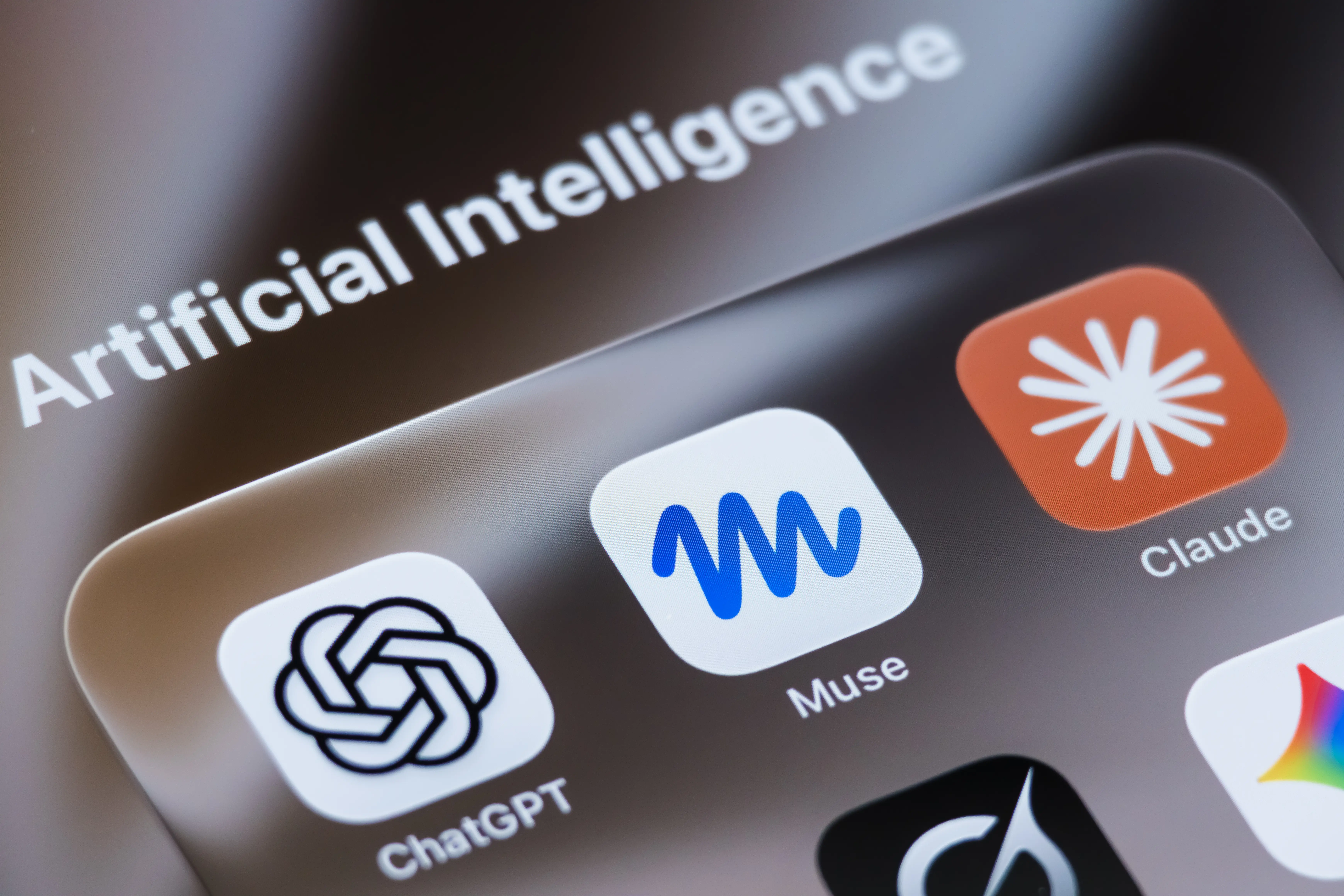 In this photo illustration, the app icons for ChatGPT, Meta's Muse and Anthropic's Claude are displayed in a folder labeled 