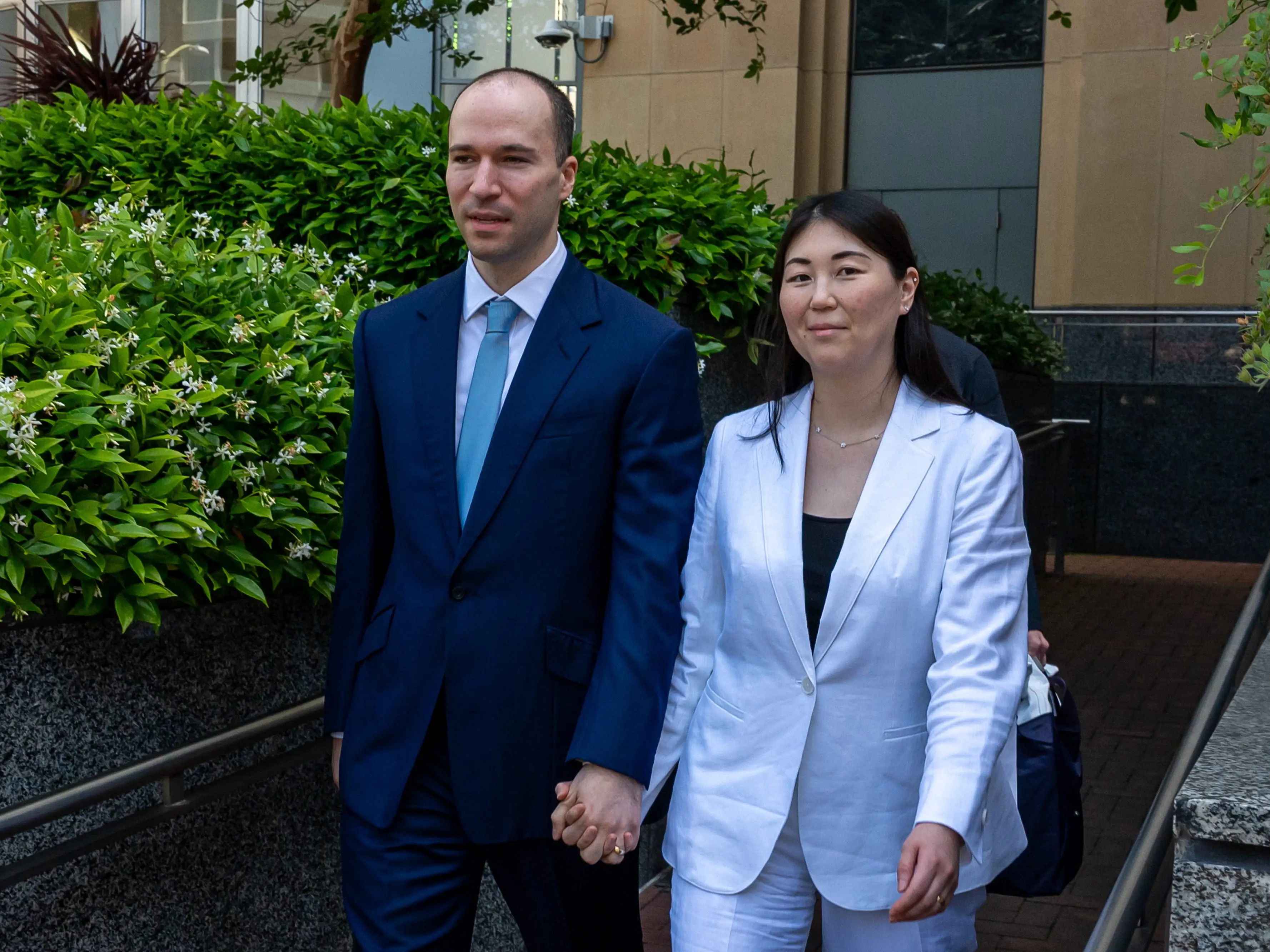 Greg and Anna Brockman are seen exiting federal court