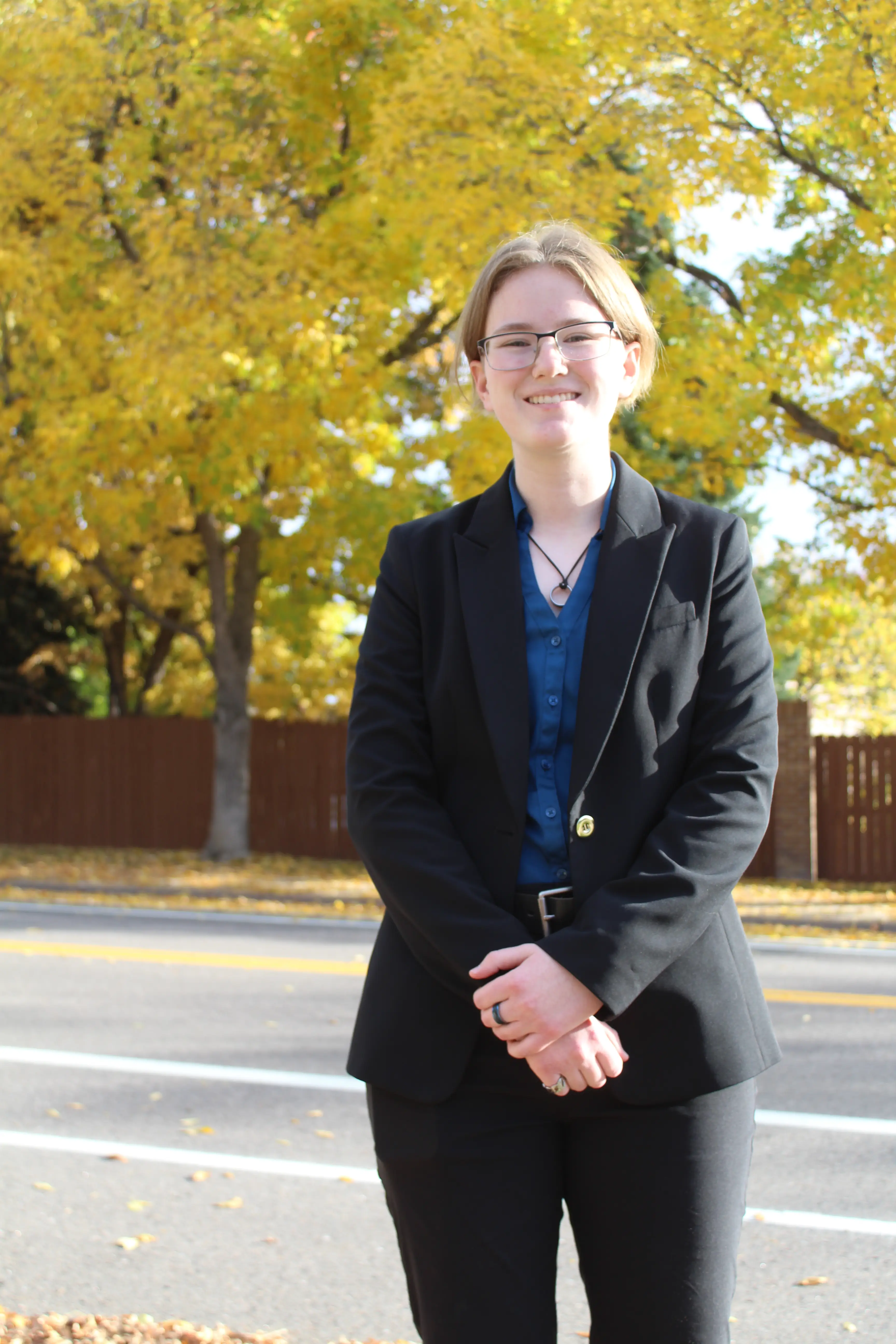 Hannah Mitchell in a black suit.