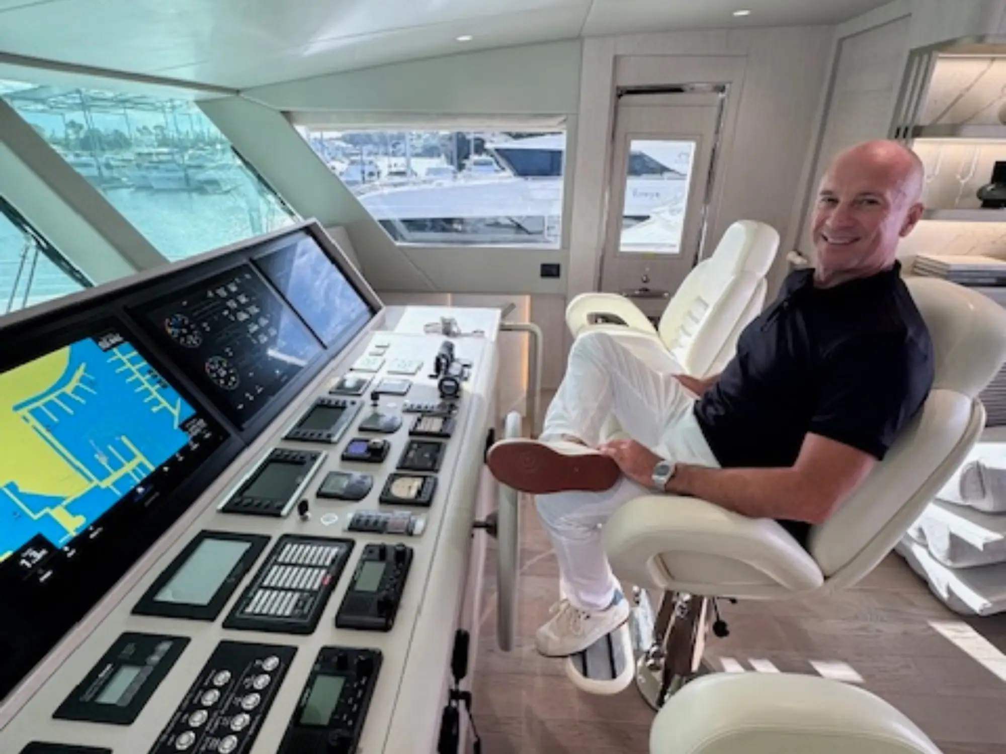 The captain of a luxury yacht sits in the control room.
