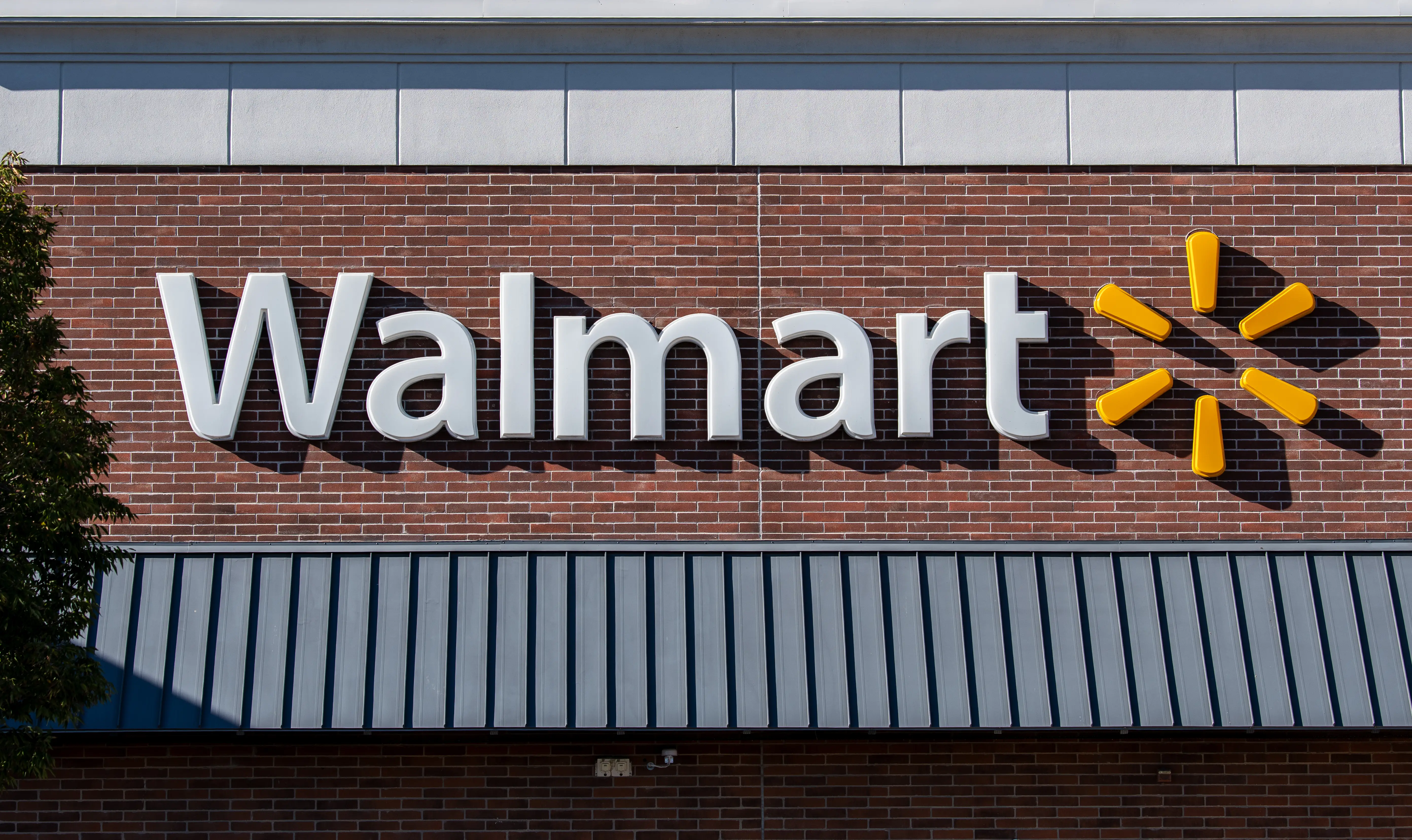The exterior corporate logo of a Walmart retail storefront is seen in Saratoga Springs, Utah, United States,