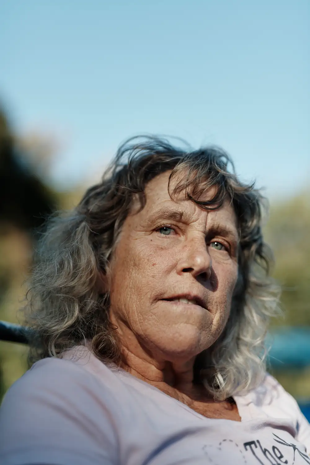 A woman with gray hair looking pensive