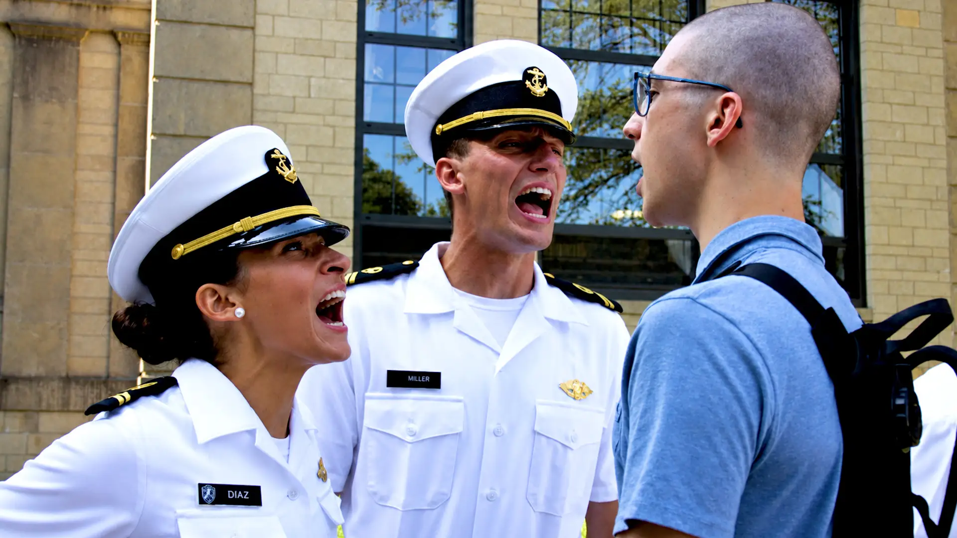 Marines in uniform yell at a novice.