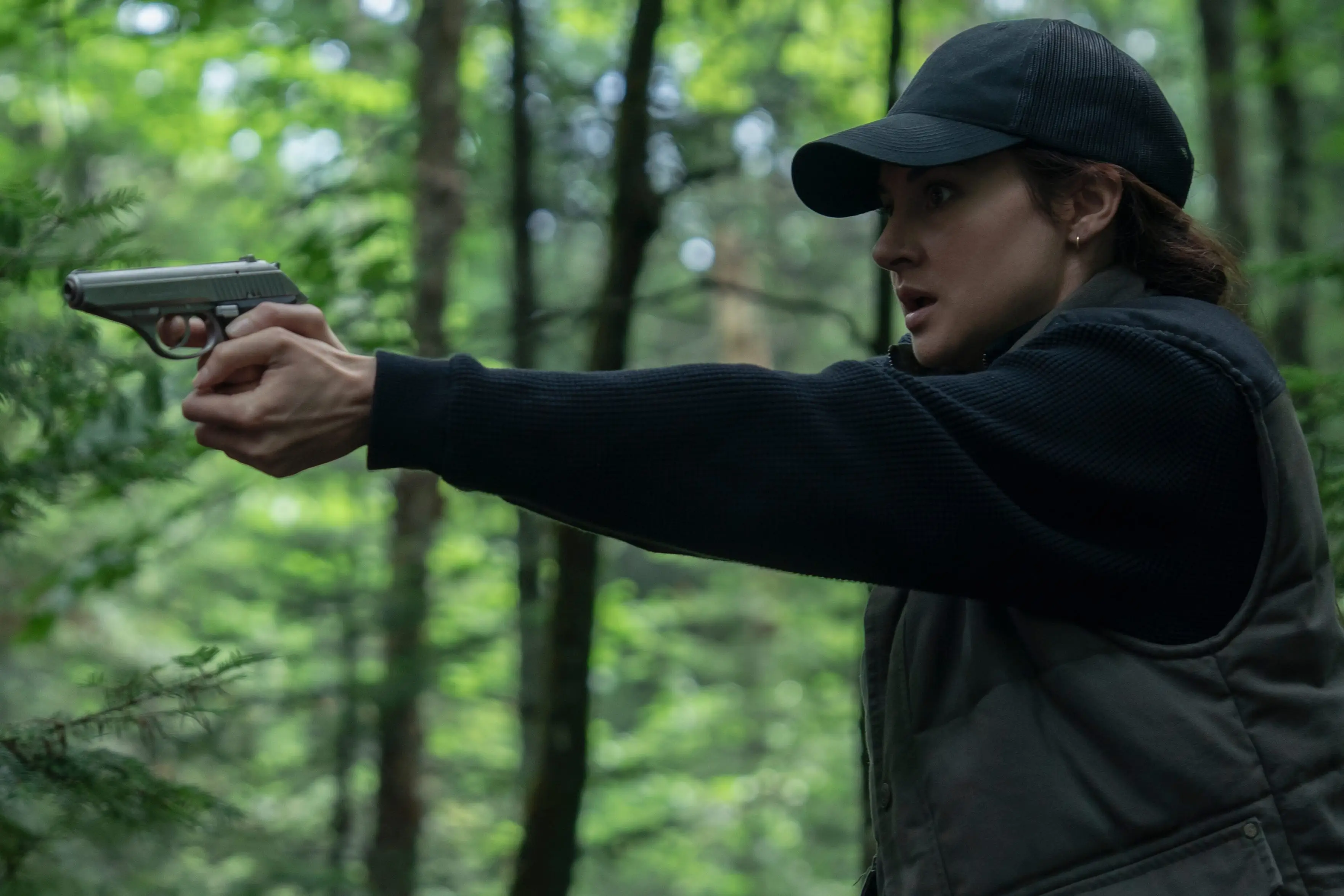 Shailene Woodley holding a gun in the woods in Unabomber movie