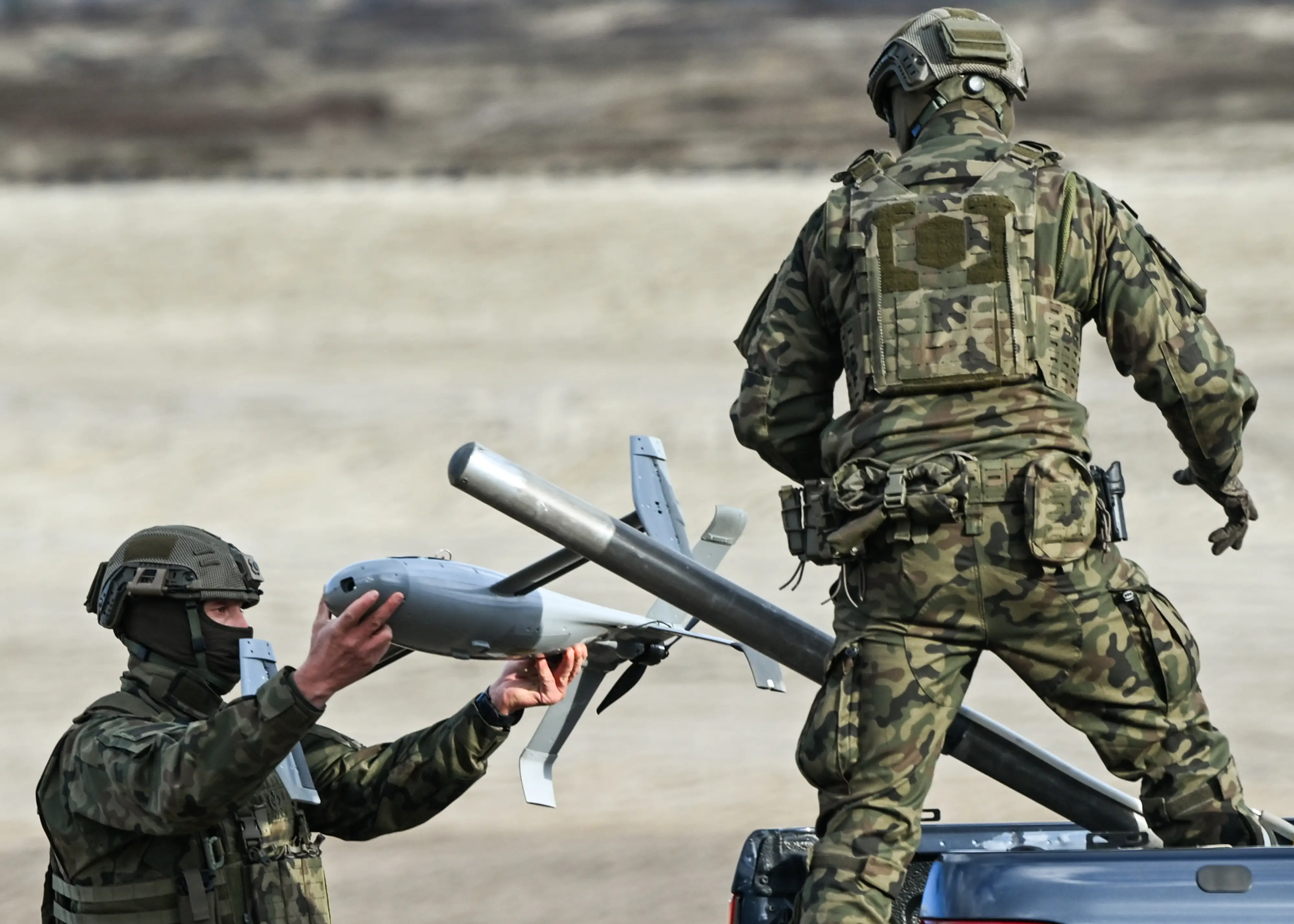 A US soldier installs an AS3 interceptor, part of the Merops system.
