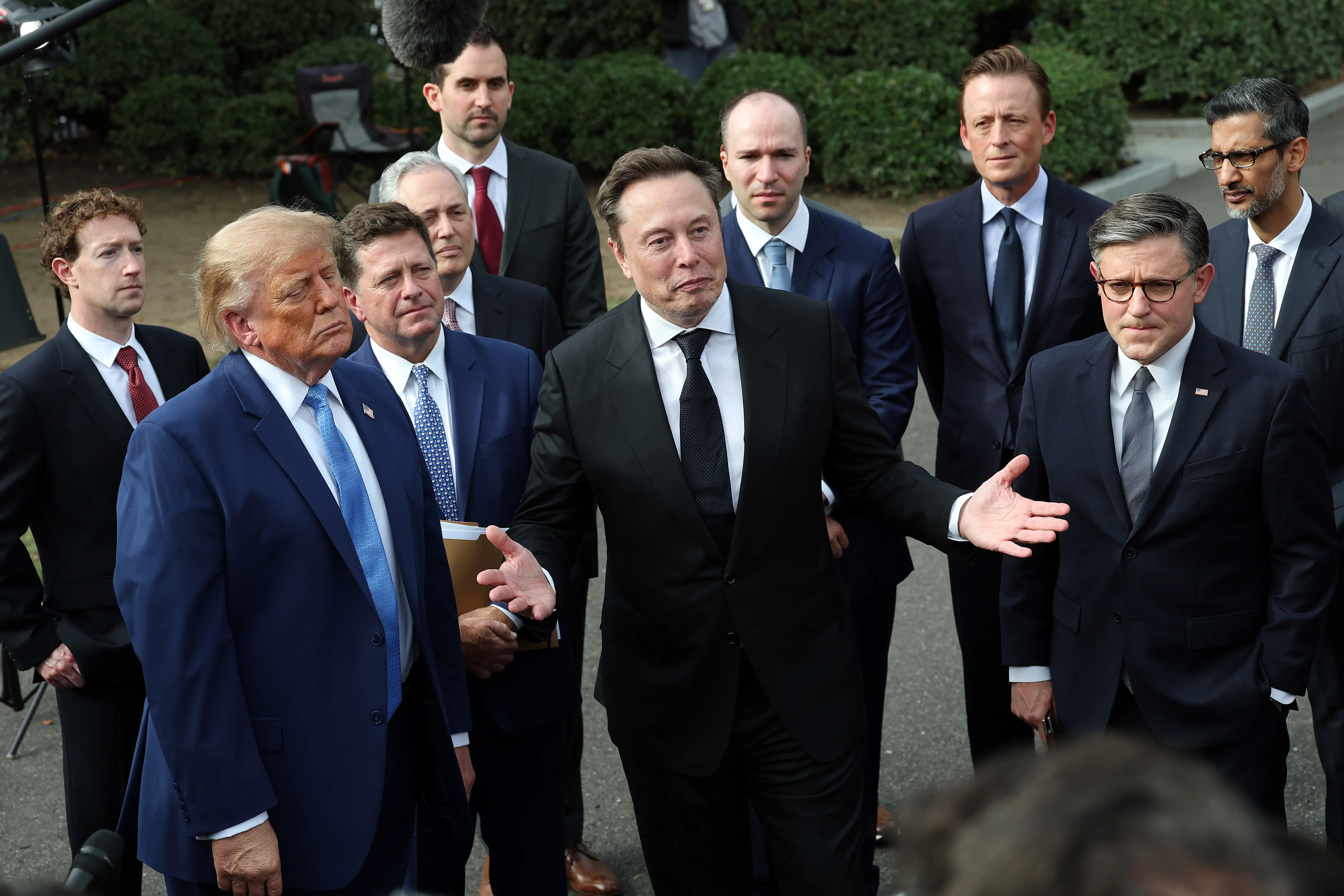SEPTEMBER 29: Elon Musk, CEO of Tesla and SpaceX, stands with U.S. President Donald Trump, Mark Zuckerberg, CEO of Meta Platforms, Speaker of the House Mike Johnson (R-LA) and others holds a press briefing with AI executives following a meeting on artificial intelligence outside the West Wing of the White