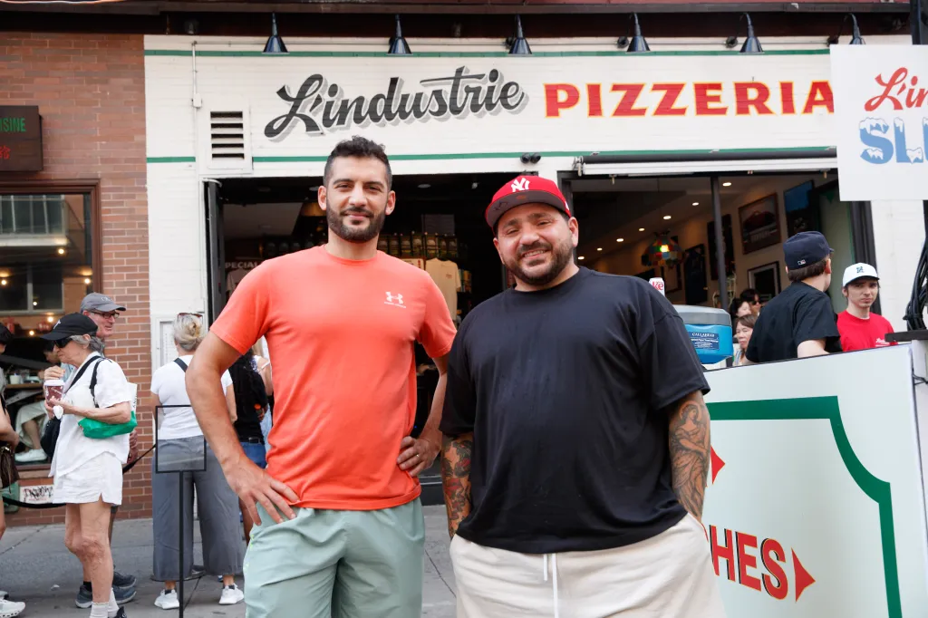 L'Industrie Pizza co-owners Massimo Laveglia (left) and Nicholas Baglivo (right) posing on Grand Street.